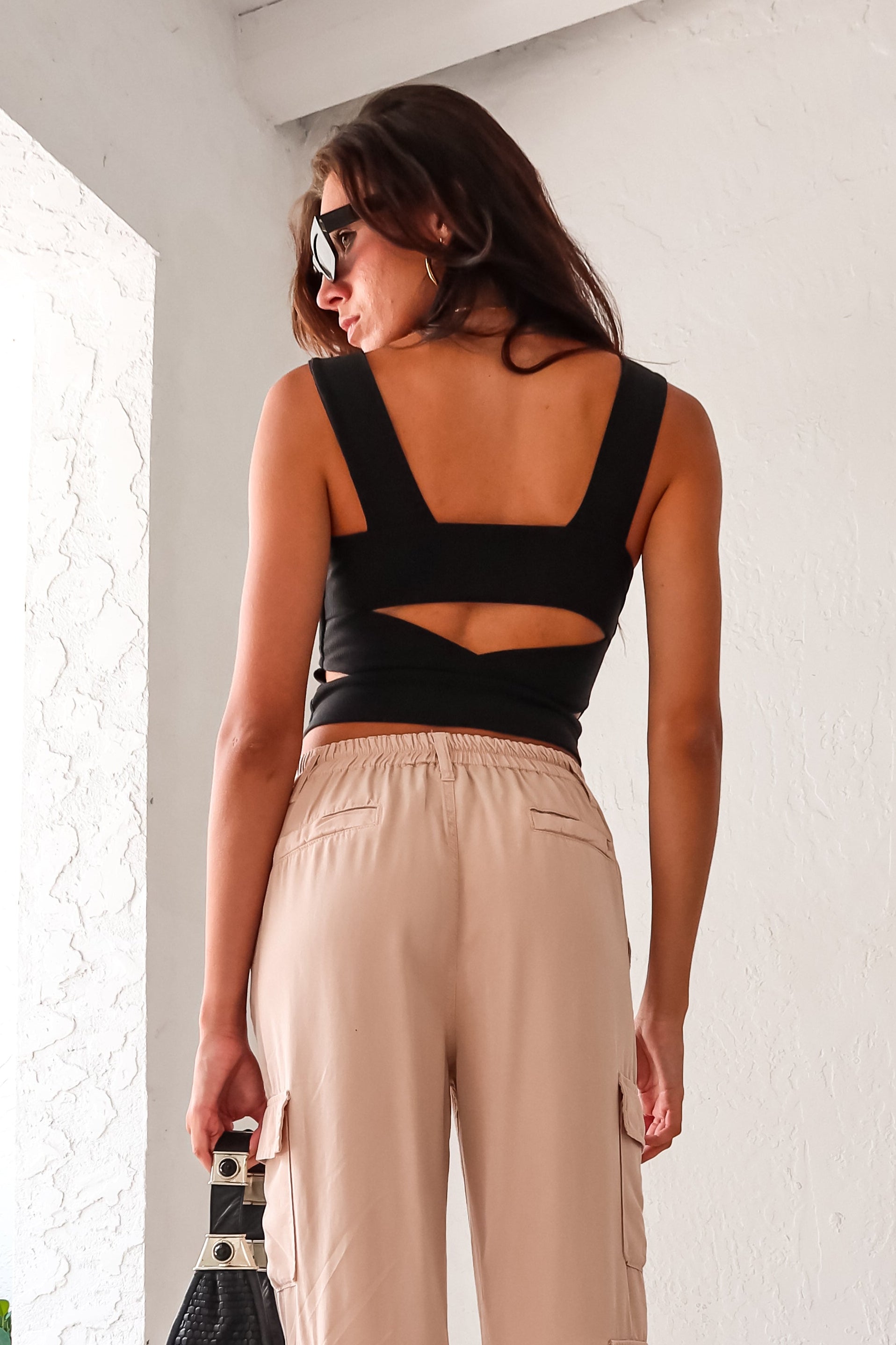 Get ready to rock your next look with our BETTER THIS TIME TANK! The black ribbed tank top is both stylish and versatile, with a unique back cutout design for an extra edge. It's also lined and made with stretchy fabric for a comfortable fit. It's time to take your fashion game to the next level!