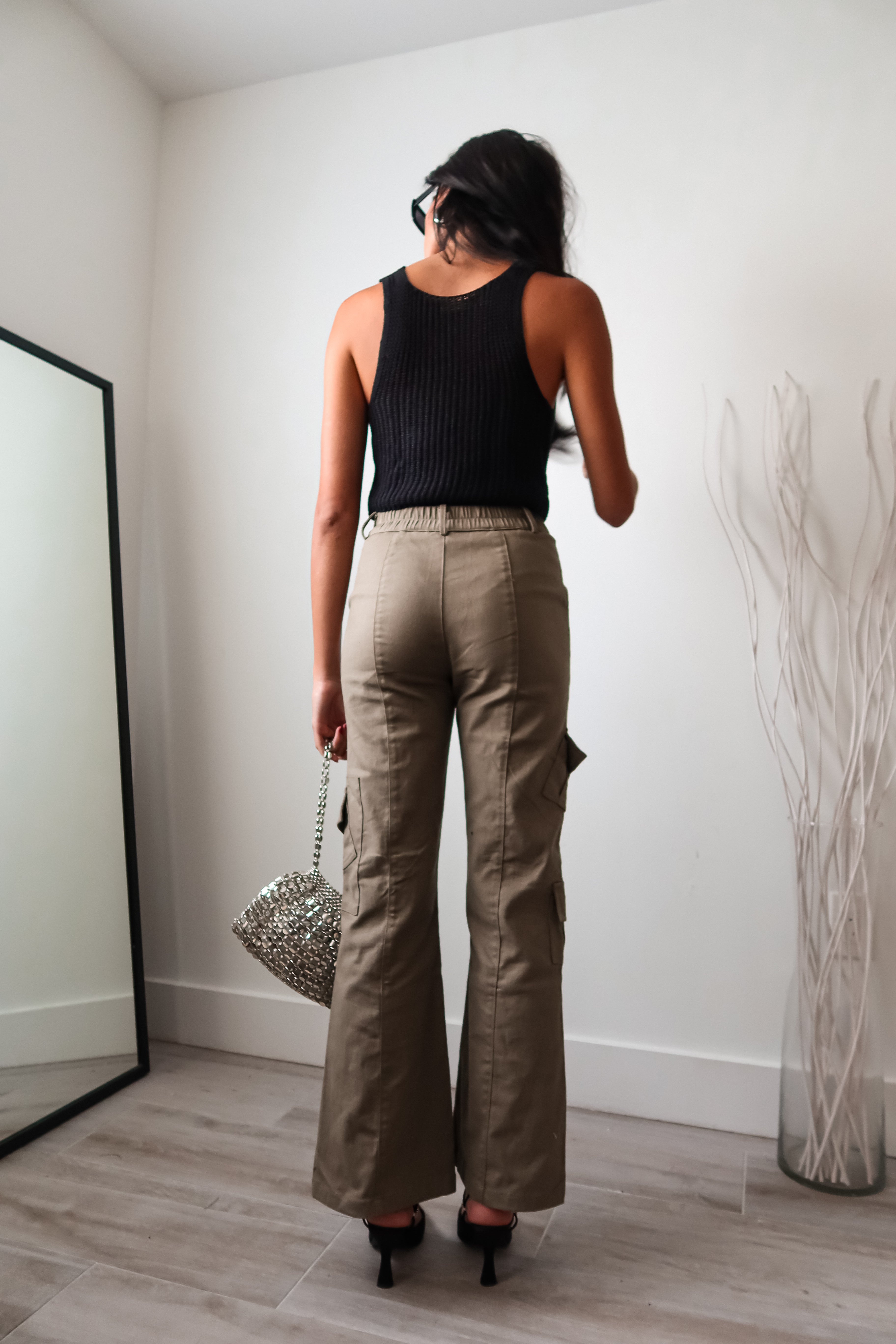 The EASTSIDE KNIT VEST TOP is a must-have tank top for any fashion-forward wardrobe. Made from a luxurious and stretchy knit material, this tank features a split front design with a hook closure for added style. It's no surprise that this top is a best seller - perfect for any occasion!