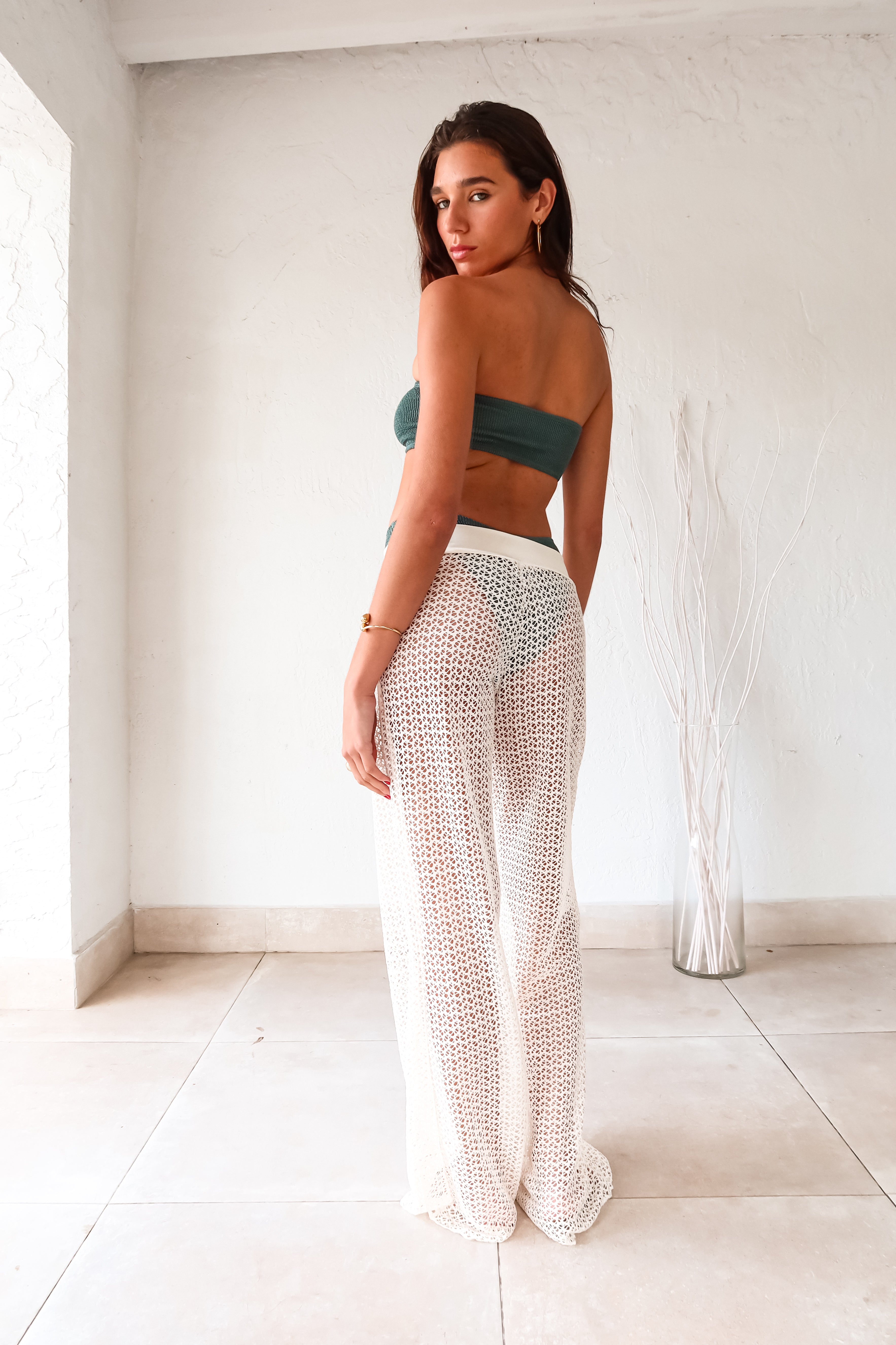 Get ready to slay in style with our NEWPORT PANT - WHITE! These versatile cover up pants are a must-have for any wardrobe. The wide leg design creates a flowy silhouette, while the elastic waist ensures a comfortable fit. Made from stretchy fabric, these pants offer both style and flexibility.