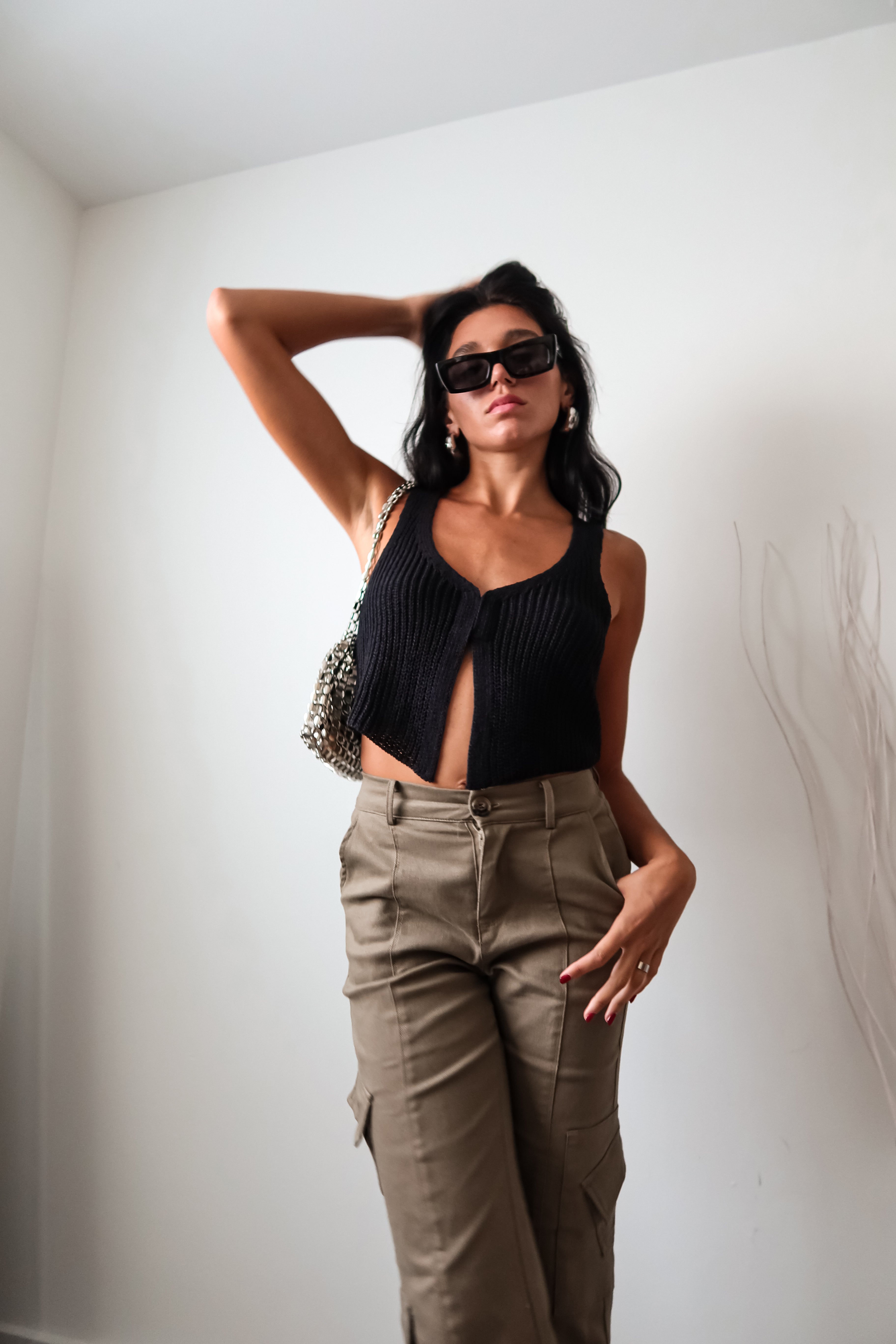 The EASTSIDE KNIT VEST TOP is a must-have tank top for any fashion-forward wardrobe. Made from a luxurious and stretchy knit material, this tank features a split front design with a hook closure for added style. It's no surprise that this top is a best seller - perfect for any occasion!