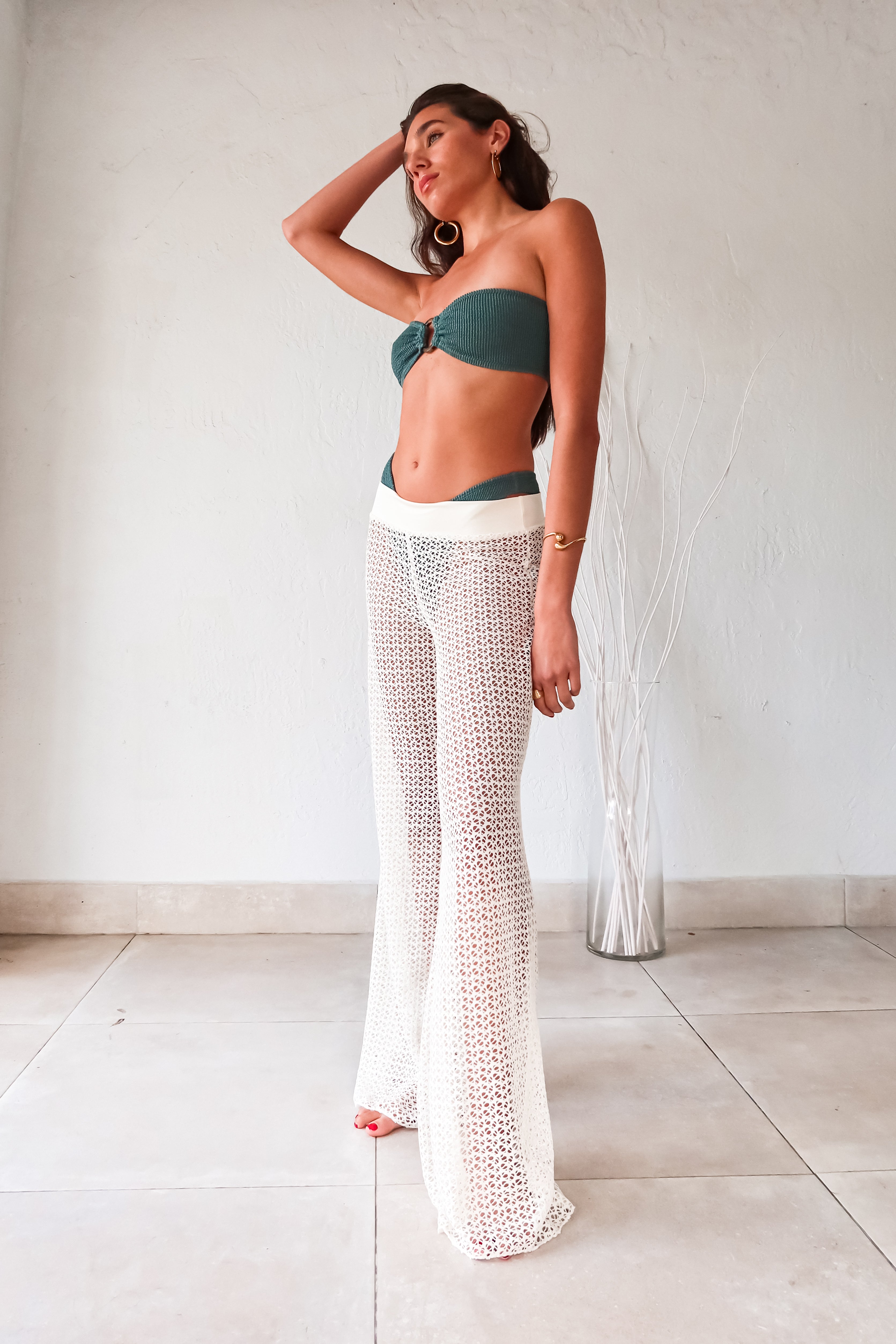 Get ready to slay in style with our NEWPORT PANT - WHITE! These versatile cover up pants are a must-have for any wardrobe. The wide leg design creates a flowy silhouette, while the elastic waist ensures a comfortable fit. Made from stretchy fabric, these pants offer both style and flexibility.