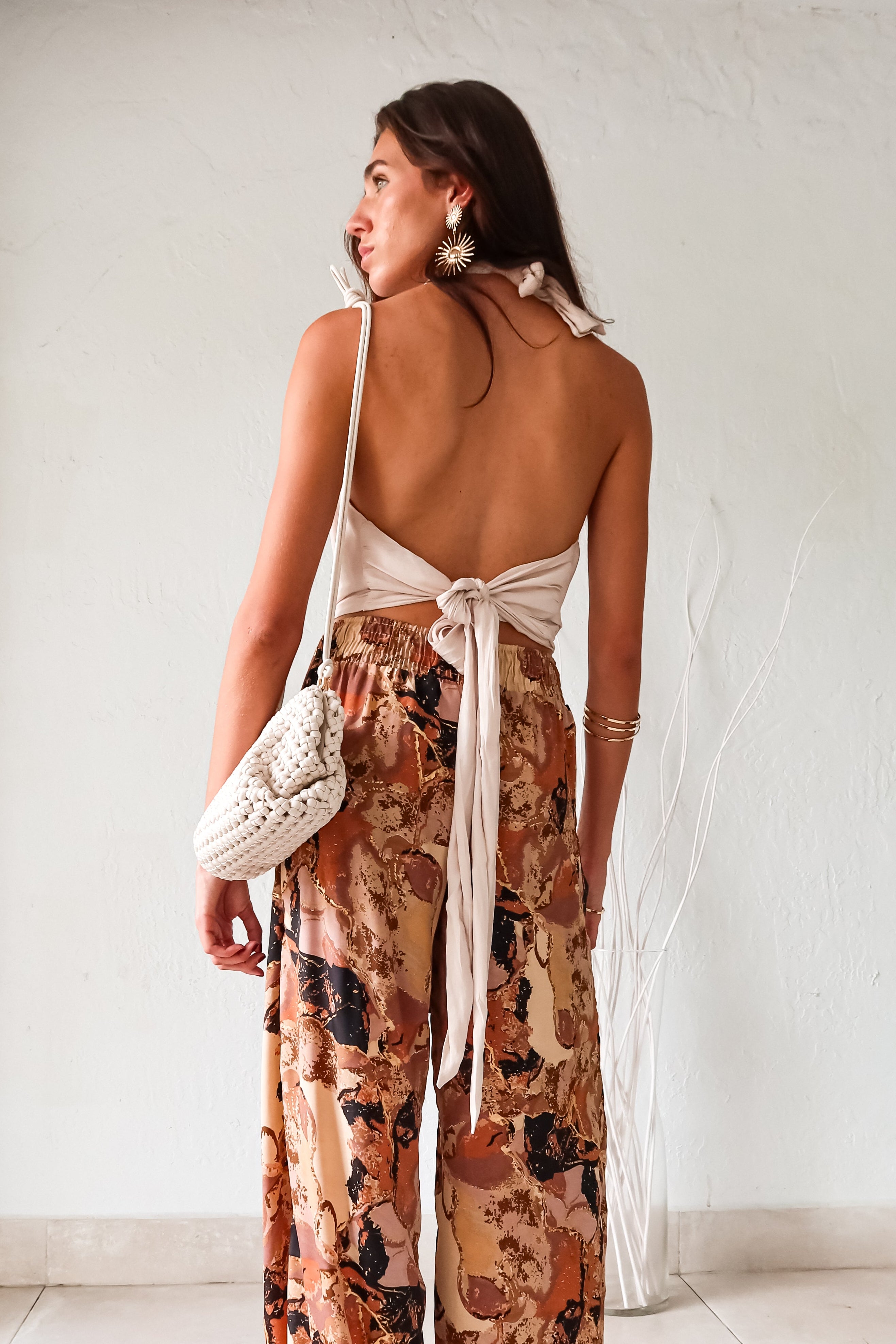 Wrap yourself in style with our TGIF Satin Wrap Top in papyrus. The back tie around the neck and waist allows for a customizable fit, while the cowl neck adds a touch of elegance. Made with a non-stretch fabric and unlined, this top is perfect for a night out. Note: Runs big - size down for the best fit!