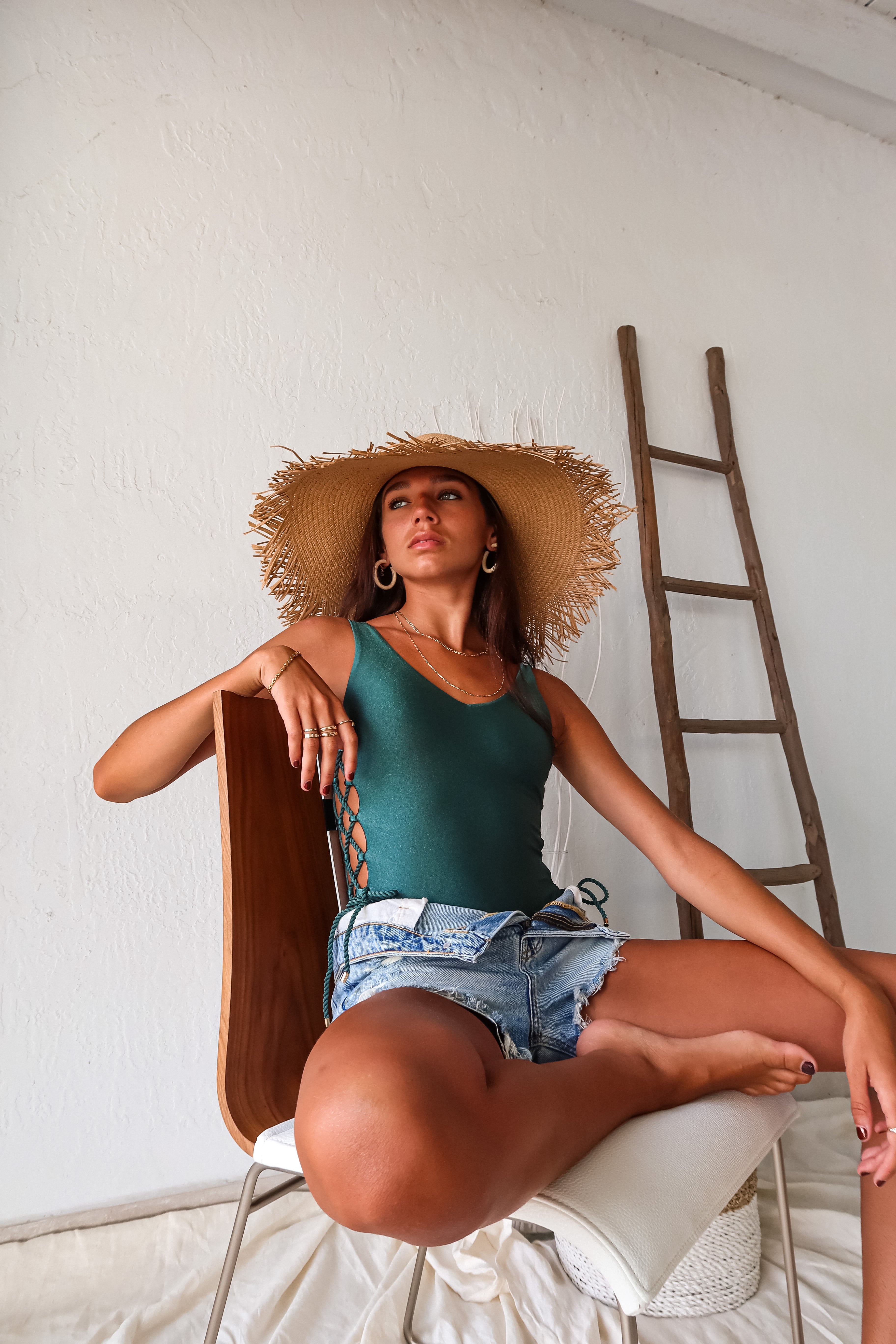 Get ready to shimmer and shine in our ISLA SHIMMER LACE UP ONE PIECE. The emerald color and gold hardware add a touch of luxury, while the high leg and cheeky bottom show off your curves. The open back detailing adds a subtle hint of sexiness, making this swimsuit a must-have for your next beach getaway.