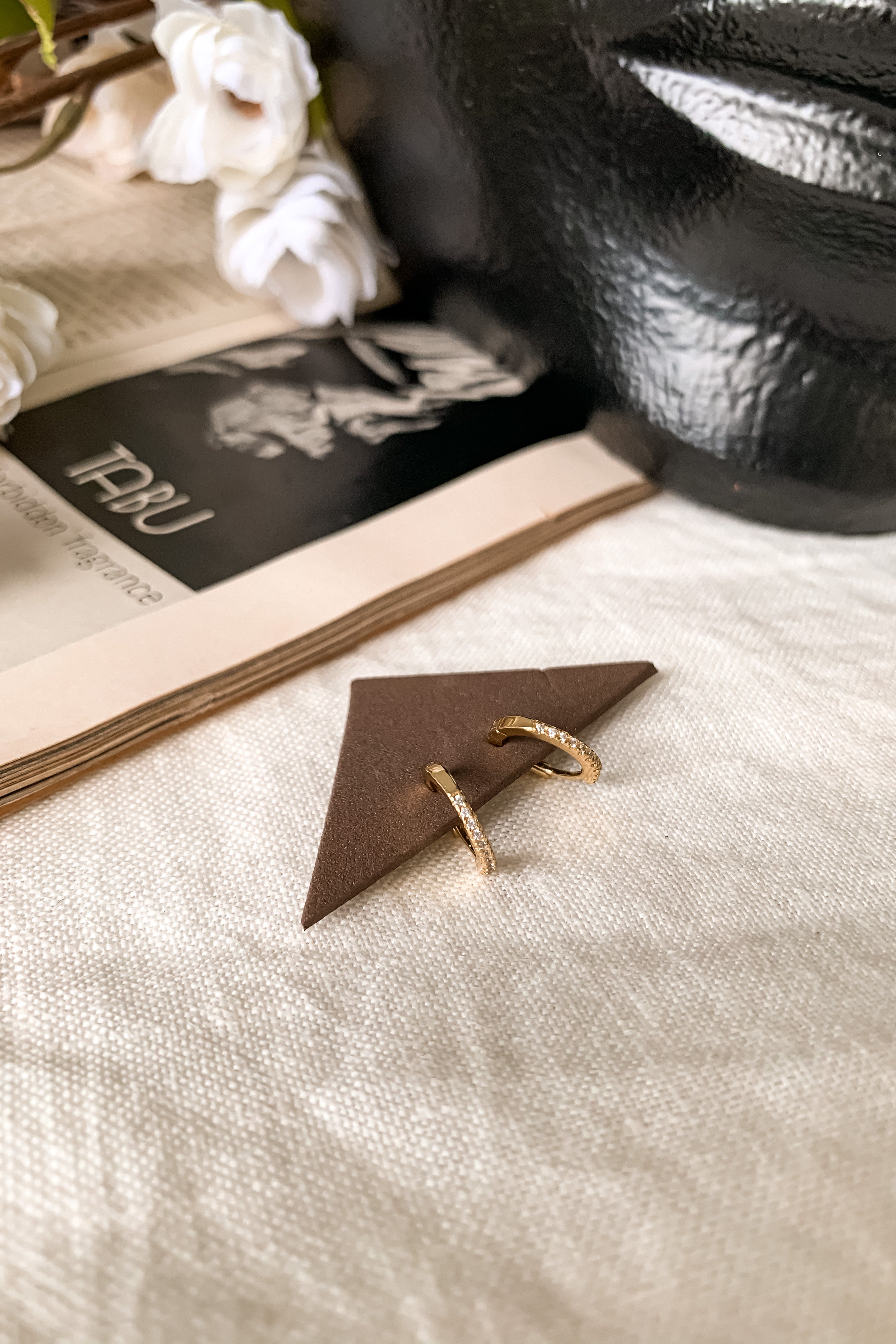 Add a touch of glam with these pave huggie earrings. Gold plated over sterling silver, these hoops offer a secure wire closure and 2 cm length. Perfect for everyday wear (and showing off!).