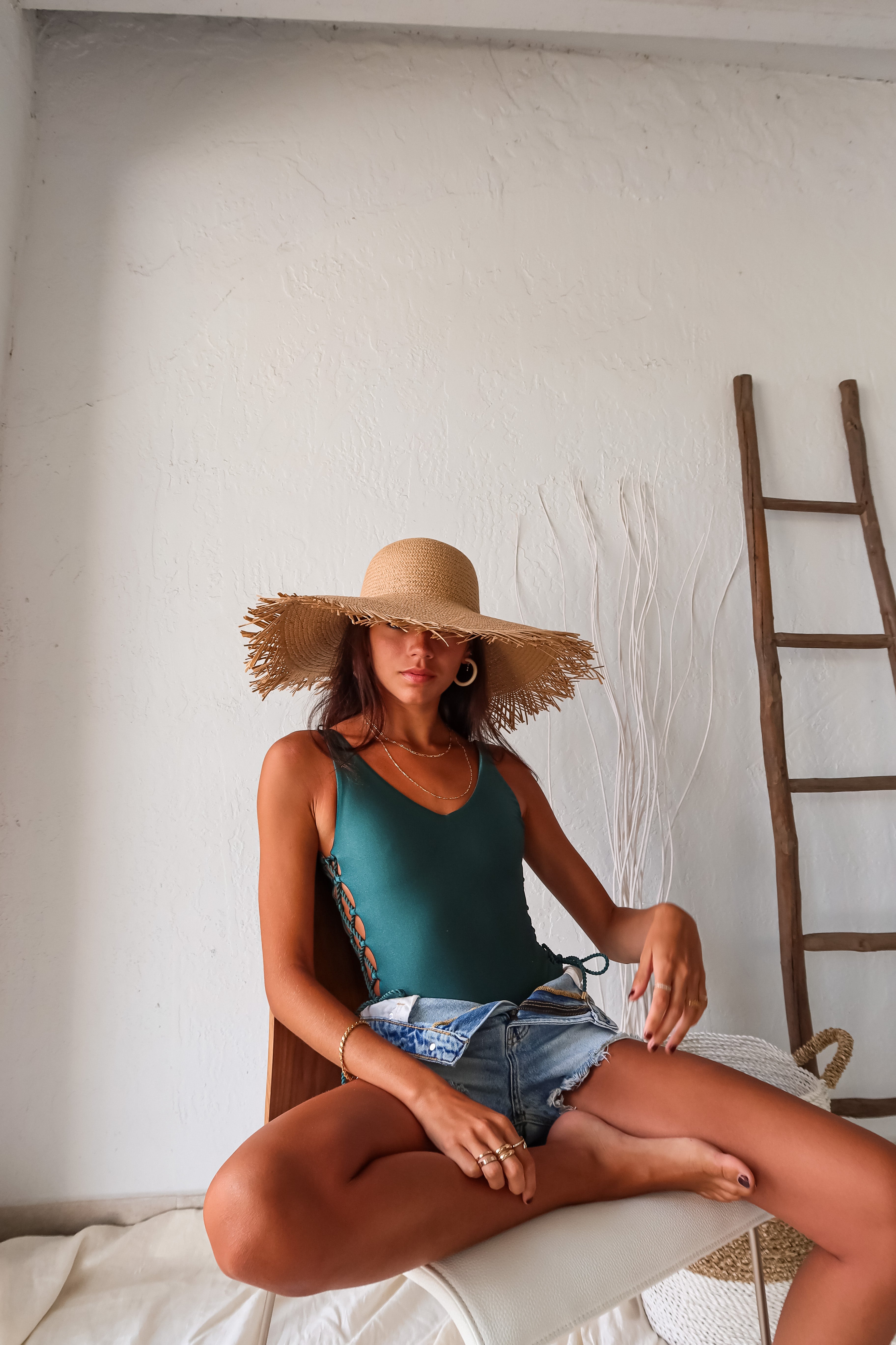 Get ready to shimmer and shine in our ISLA SHIMMER LACE UP ONE PIECE. The emerald color and gold hardware add a touch of luxury, while the high leg and cheeky bottom show off your curves. The open back detailing adds a subtle hint of sexiness, making this swimsuit a must-have for your next beach getaway.
