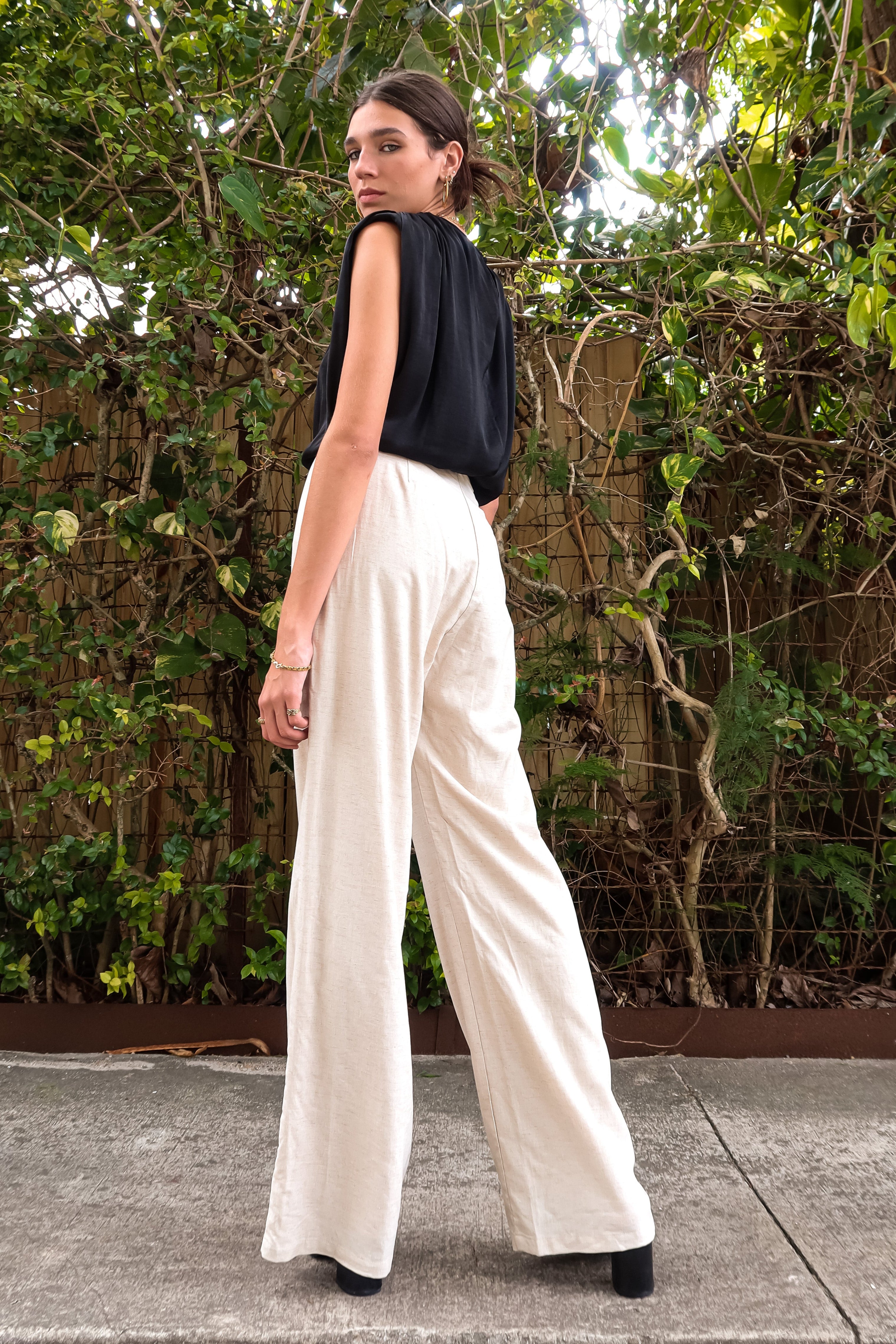 BRICKELL SATIN TOP - BLACK. This black satin top features padded shoulders and an adjustable bottom hem drawstring for ultimate comfort. Complete with a back button closure and made with polyester material,