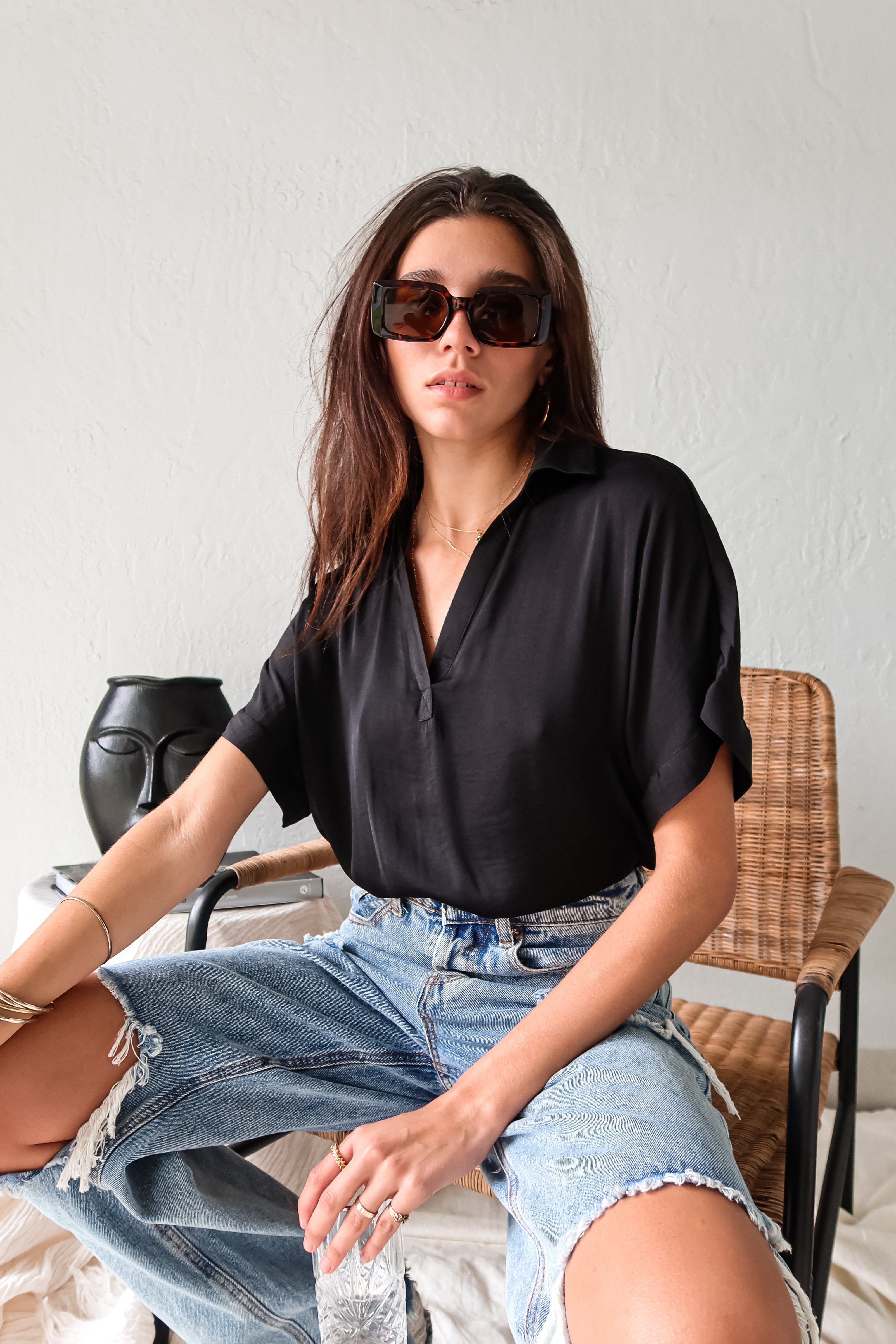 DOWNTOWN BLOUSE in classic black is a best seller for a reason. With a v-neck collared design and lightweight satin feel, this top is effortlessly chic. The cuffed sleeve adds a touch of sophistication