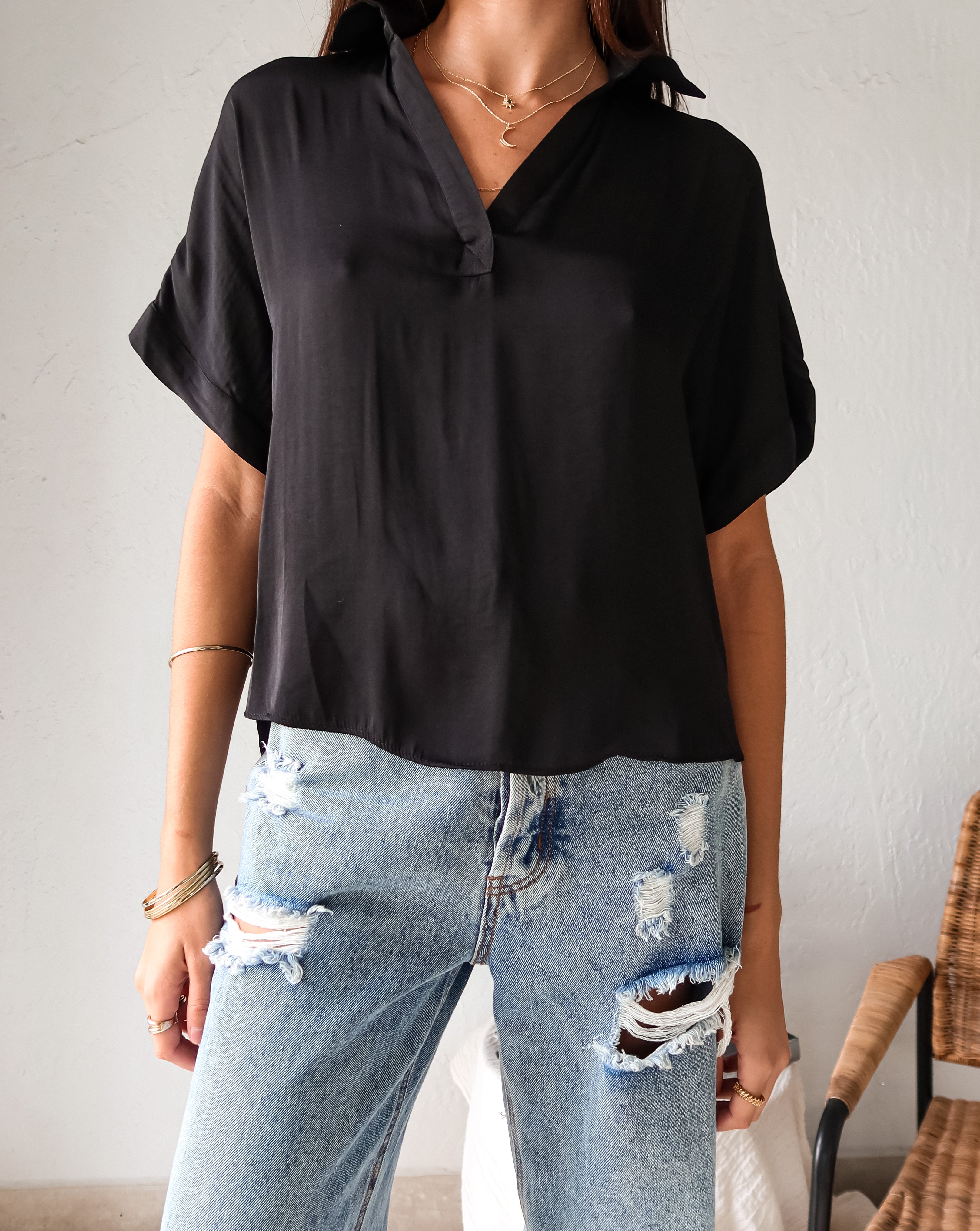 DOWNTOWN BLOUSE in classic black is a best seller for a reason. With a v-neck collared design and lightweight satin feel, this top is effortlessly chic. The cuffed sleeve adds a touch of sophistication