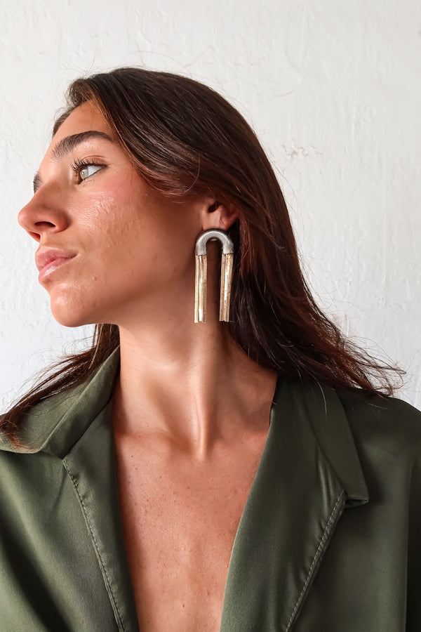 Introducing our ART DECO EARRINGS - the perfect mix of style and uniqueness. These arch shaped earrings are made from fantasy metal (lead and nickel free), ensuring a comfortable wear. With a 3 inch length, they pair perfectly with our Mia Satin Wrap blouse for a complete look. Go ahead, make a statement!