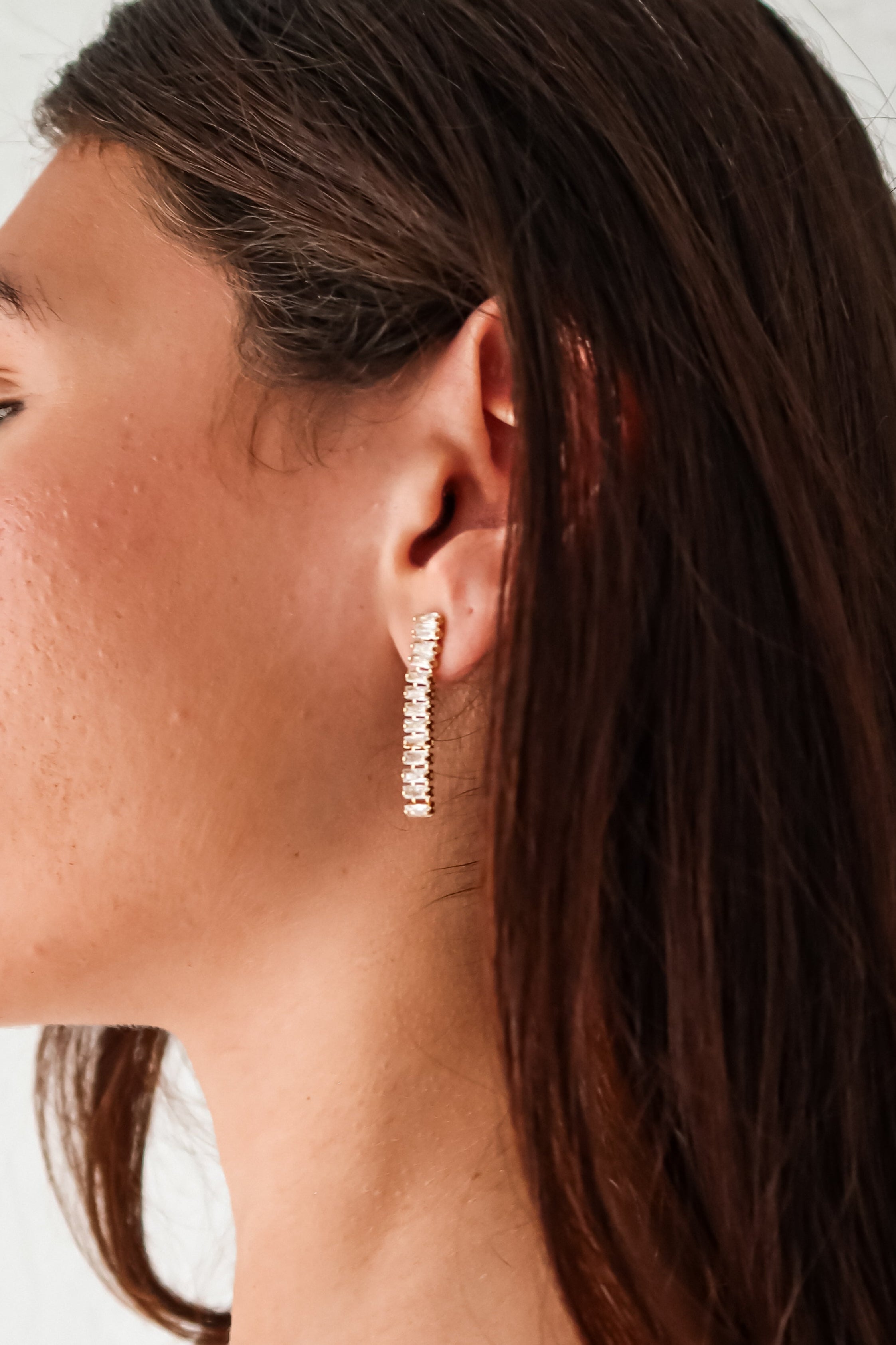 Add a touch of elegance to any outfit with our ST Baguette Drop Earrings! Designed in gold plated sterling silver, these earrings feature a unique baguette drop style with sparkling rhinestones. Tarnish resistant and hypoallergenic, they're perfect for everyday wear. (Seriously stunning.)