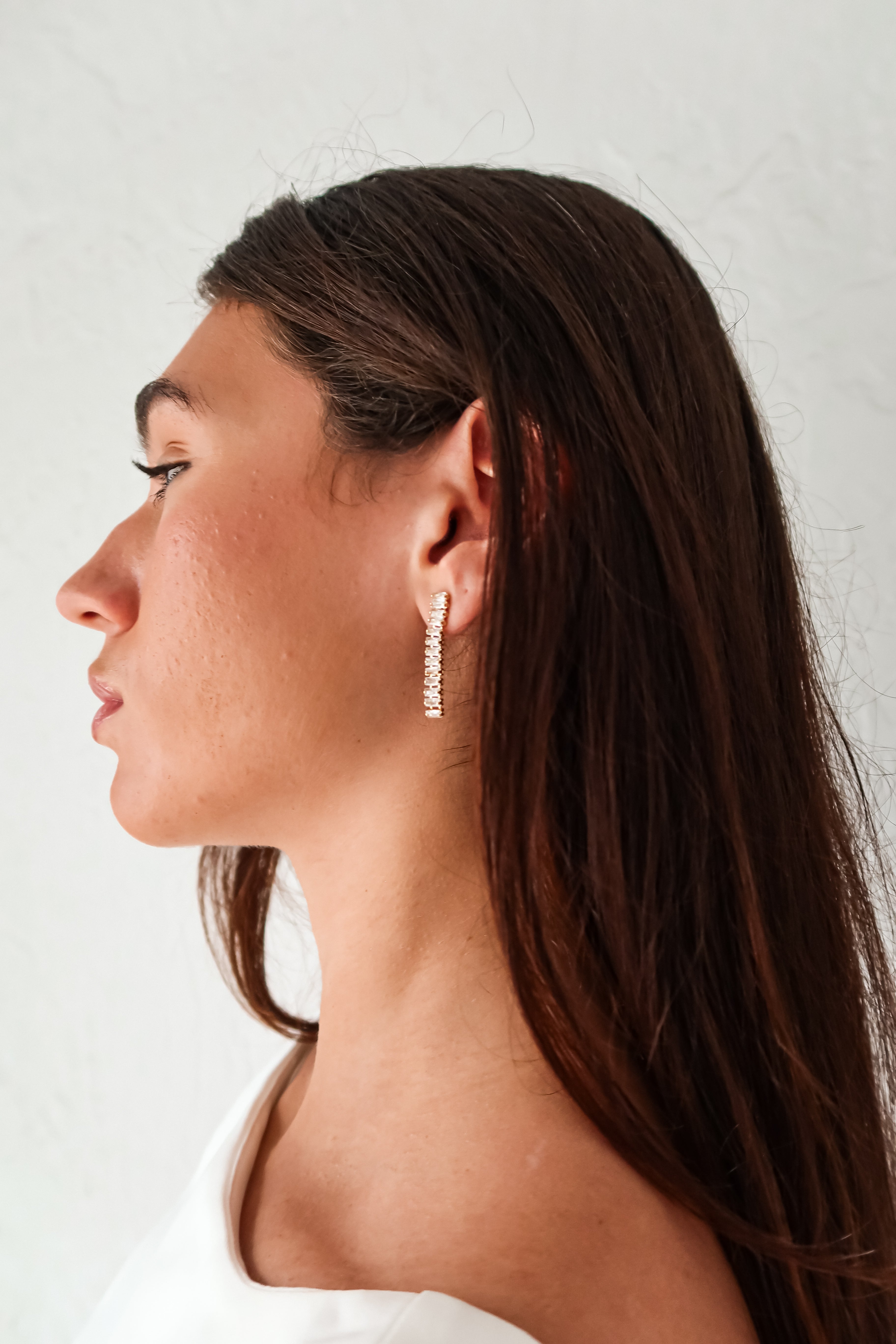 Add a touch of elegance to any outfit with our ST Baguette Drop Earrings! Designed in gold plated sterling silver, these earrings feature a unique baguette drop style with sparkling rhinestones. Tarnish resistant and hypoallergenic, they're perfect for everyday wear. (Seriously stunning.)