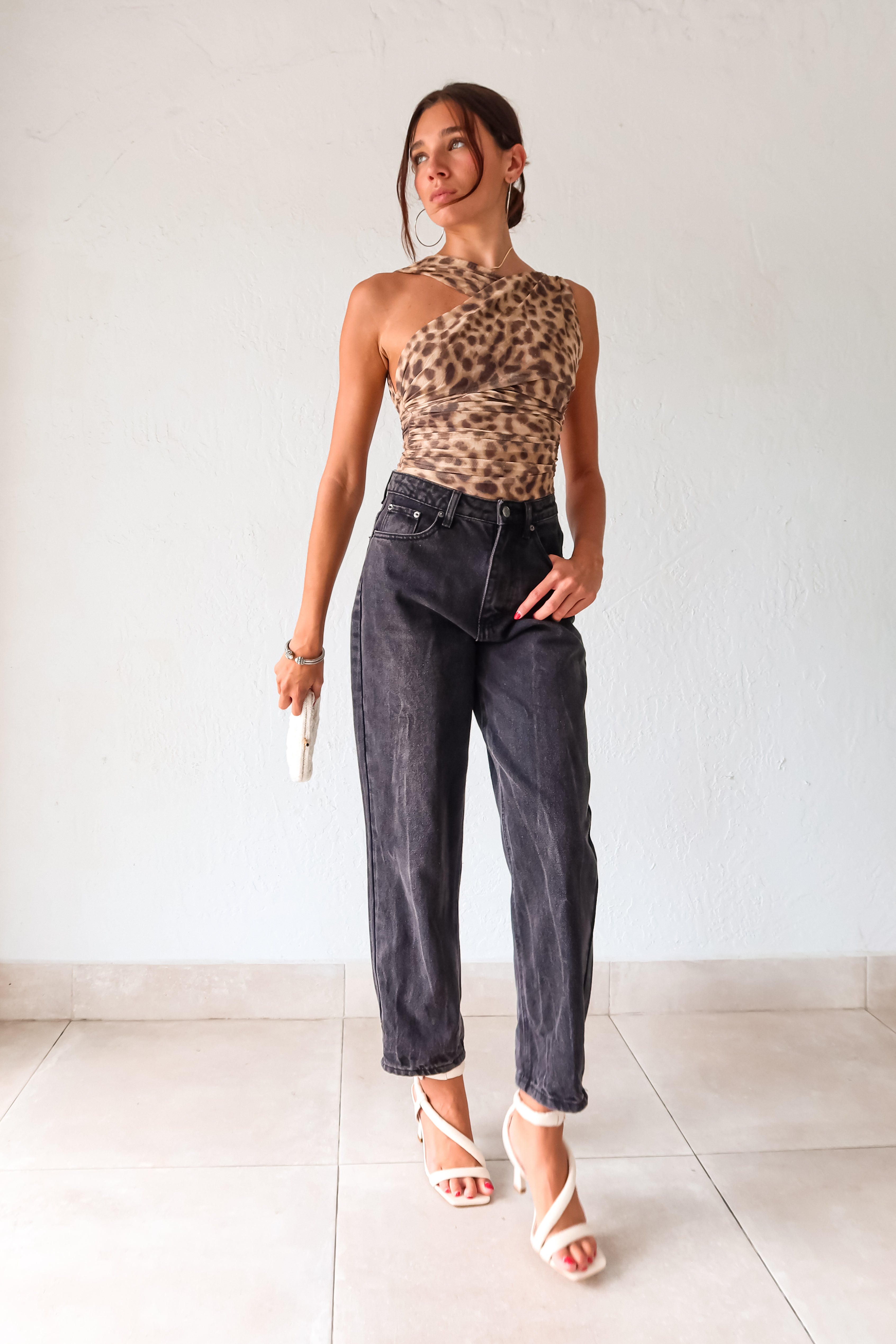 Slay in style with the Naomi Mesh Bodysuit! Featuring an asymmetrical cheetah design, this stretchy mesh bodysuit is both fierce and comfortable. The thong style with snap button closure adds convenience, while the lined front and bottom provide coverage. Perfect for a night out or a fun day in, this bodysuit will have you feeling confident and chic.