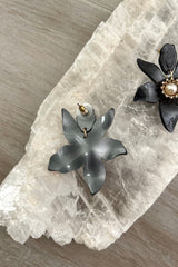 Add a touch of flower power to your look with our LE FLEUR EARRINGS! These quirky black acrylic earrings feature a gold center and pearl details, and are tarnish resistant and hypoallergenic for worry-free wear. The perfect accessory for any fun-loving fashionista! 