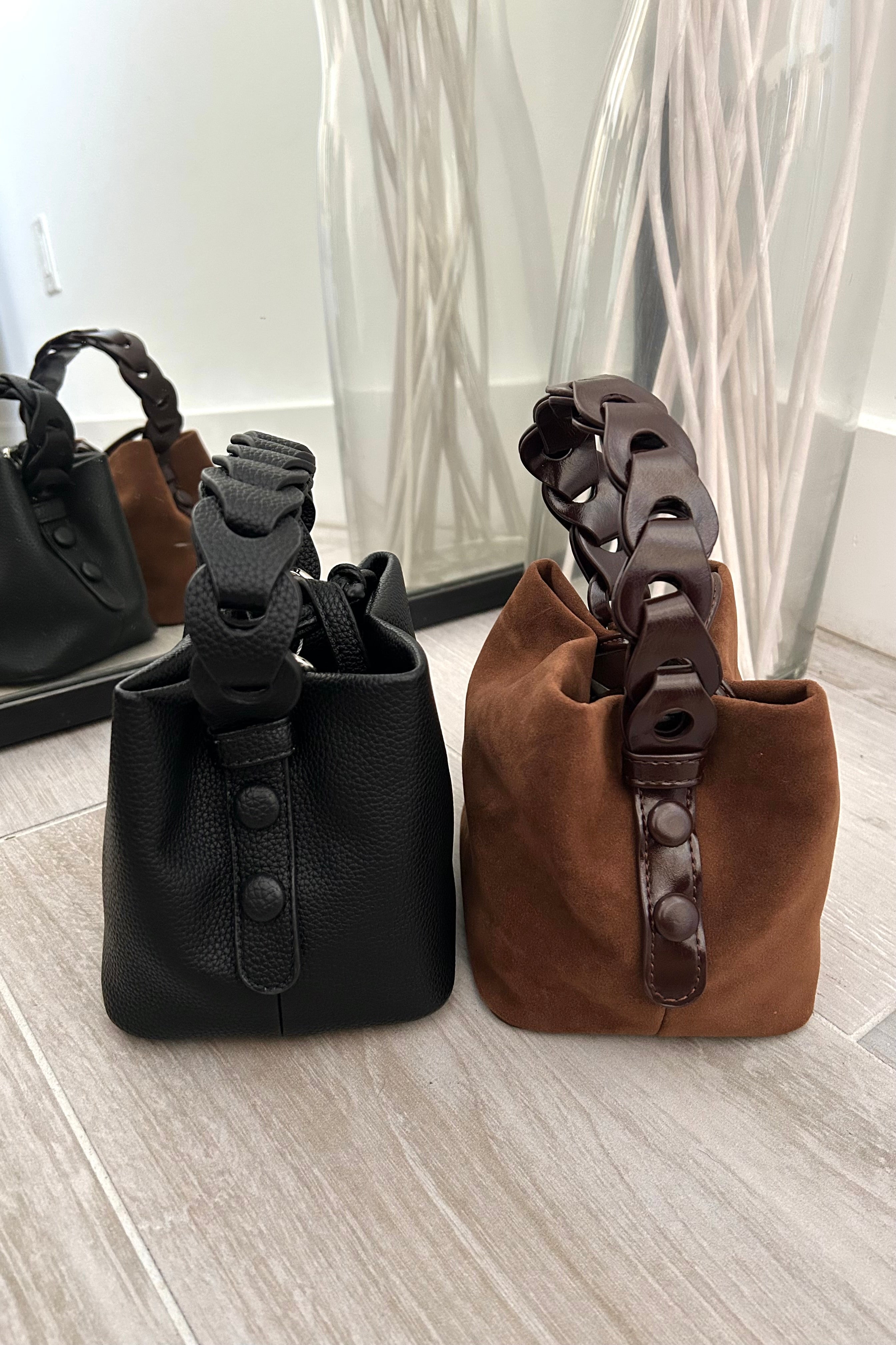 Meet the ultimate mini bag for your everyday adventures! Our Republic Mini Bag comes in your choice of two stylish colors - brown suede or black vegan leather. Featuring a trendy hand strap design and a removable shoulder strap, it's the perfect mix of fashion and function. Plus, the flat bottom keeps your essentials upright for easy access.