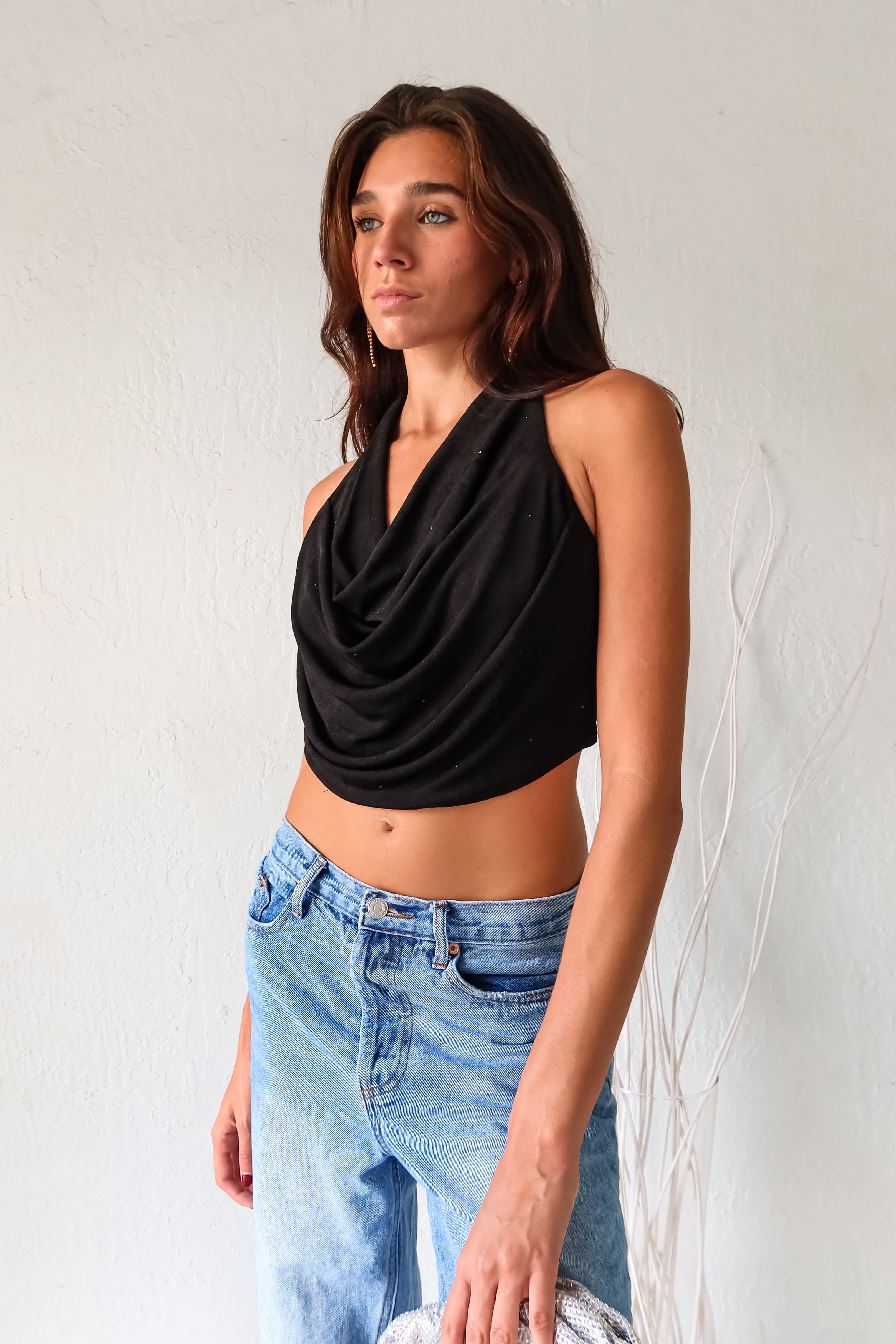 Get ready to dazzle in our Black COCOWALK SLINK HALTER TOP! The cowl bust and rhinestone accents add a touch of glamour to this playful halter. Made with stretchy fabric for all-day comfort. Tie it around your neck for a perfect fit.&nbsp;