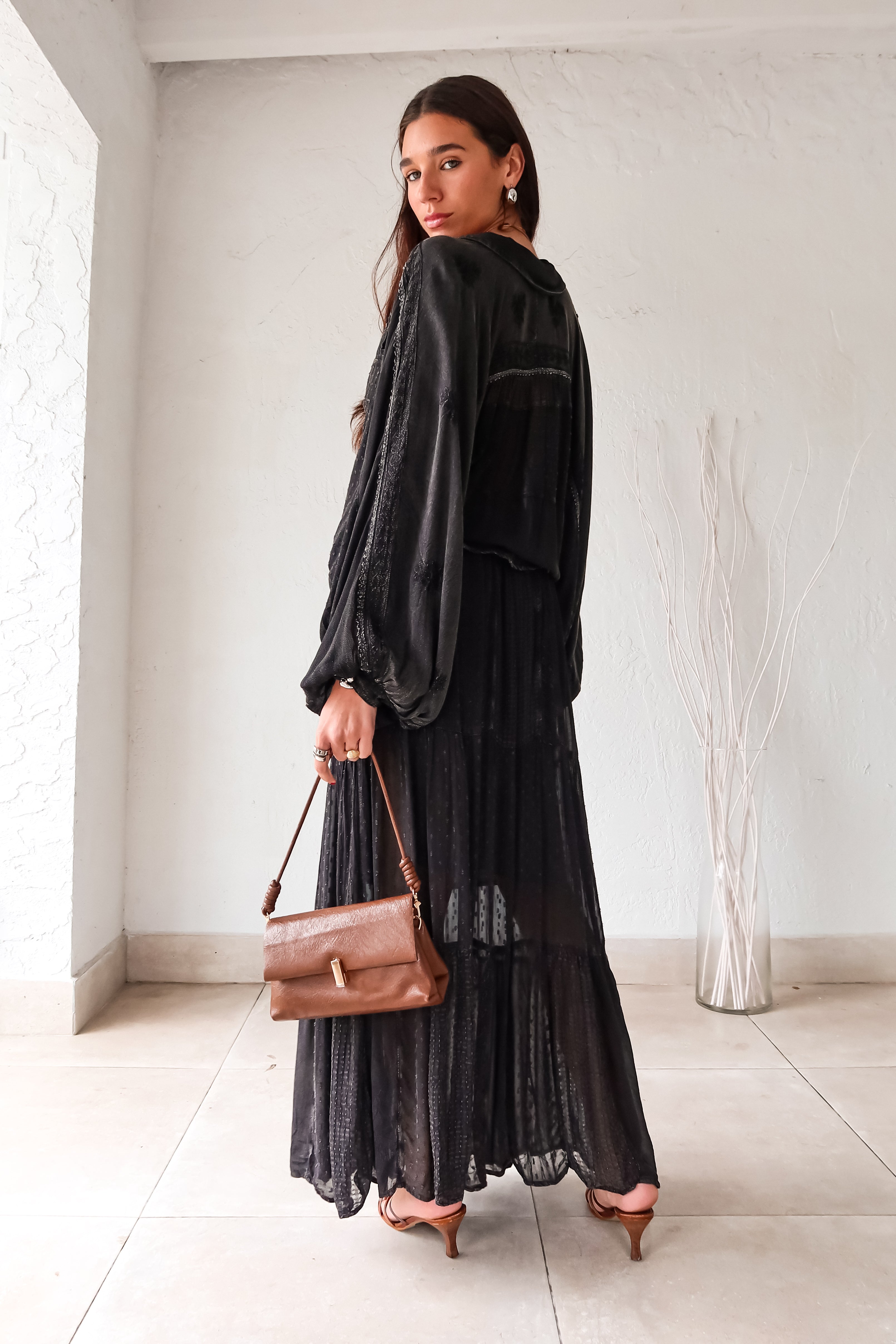 Rock your style in the playful Zeppelin Blouse in camel. This sheer chiffon shirt features a black collard design, front button down, and a convenient front left chest pocket. Versatile as a cover up, this blouse is perfect for effortless, fun fashion.