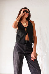 Stay cool and stylish with the London Vest Top in Black. Featuring a unique crochet design and double front tie closure, this top is perfect for any occasion. Its slight stretch ensures a comfortable fit, while the non-lined material keeps you feeling fresh.&nbsp;