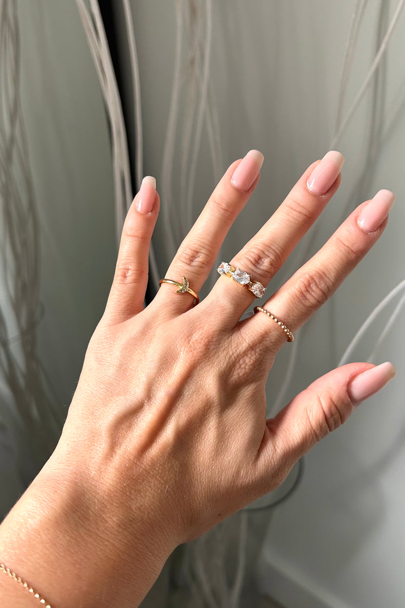 Introducing our NEW RING COLLECTION - featuring three styles to elevate your look! These gold plated over sterling silver rings are both tarnish resistant and hypoallergenic. Add a touch of elegance with the Emerald Square Ring, a dash of boho with the GF Beaded Ring, or embrace your inner moon child with the Pave Mini Crescent Ring. Choose your style and shine on!