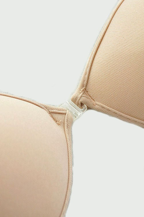 Introducing the ANGEL BRA, the super lightweight and natural-feeling bra that provides cleavage, lift, and invisibility under sheer clothing. With its adhesive inner lining and fabric outer shell, as well as a clear plastic front clasp, this bra is perfect for backless and strapless tops and dresses. Plus, it's reusable and comes in a variety of sizes based on cup size. Get the perfect fit and look effortlessly stunning. Try the ANGEL BRA today!