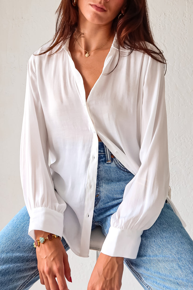 Put a playful twist on your classic work attire with our GABLES LONG SLEEVE BLOUSE. This white, non-lined button down blouse is both lightweight and comfortable for all-day wear. With long sleeves and button wrists, this blouse is perfect for any season. Don't settle for boring office wear, stand out in style!