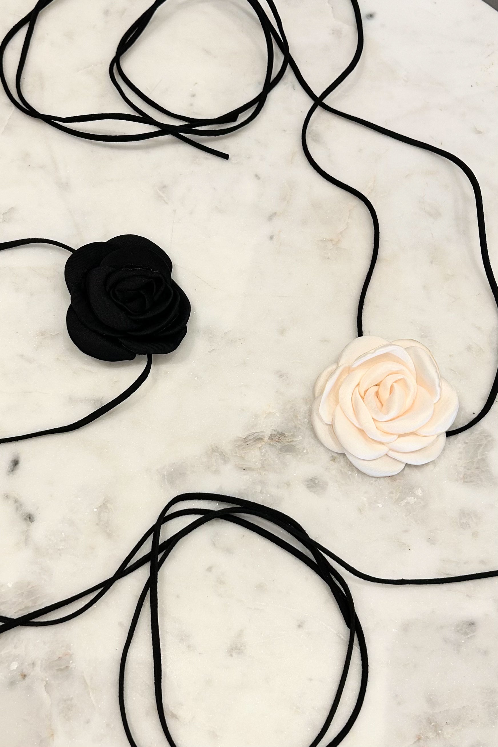 Unleash your inner flower child with our LE FLEUR CHOKER! This choker is the perfect mix of edgy and feminine, featuring a off white flower and black faux suede string. Whether you wear it as a necklace or belt, this versatile piece will add a touch of fun to any outfit.