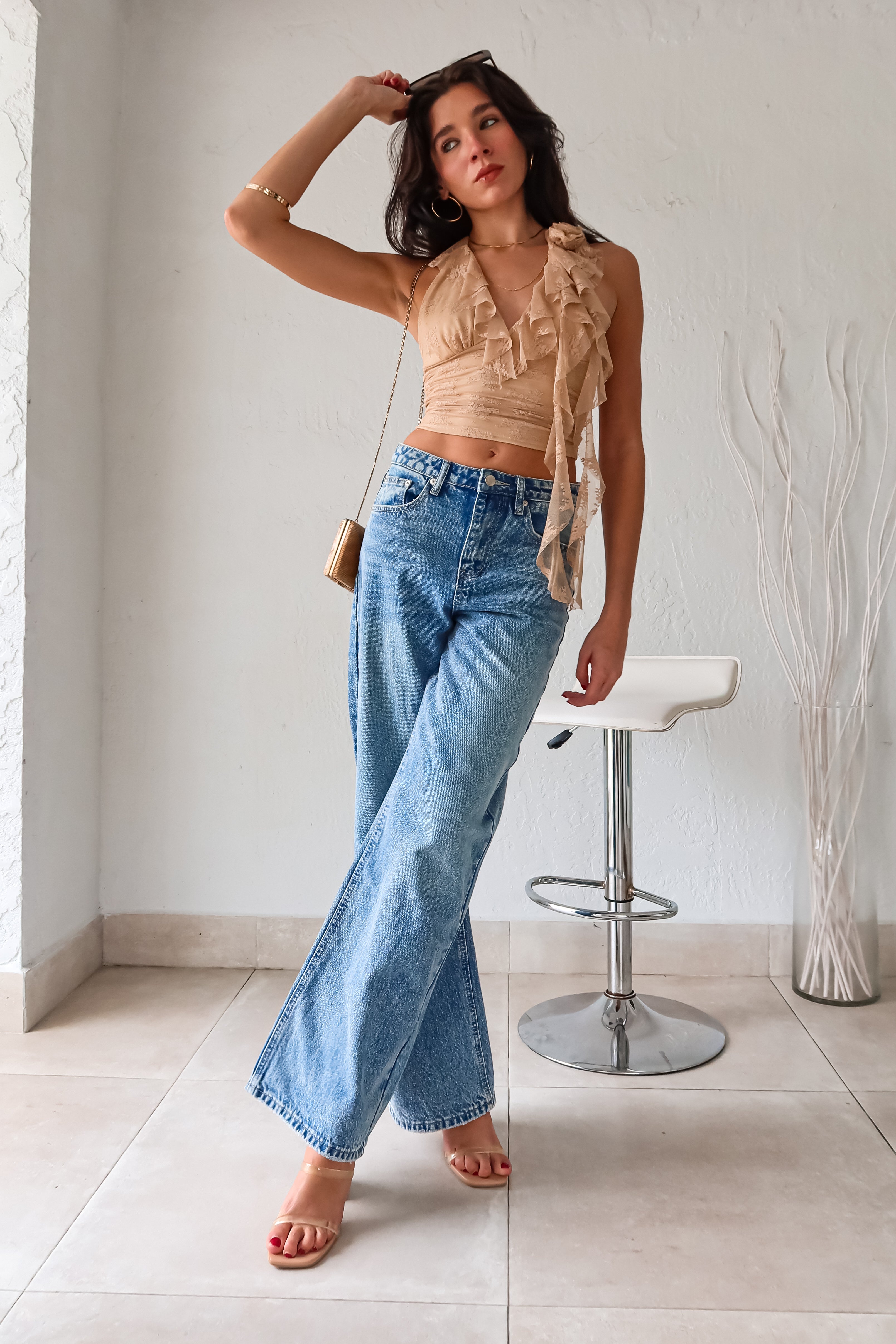 Make a statement in our BELLPORT DENIM PANT. With a medium wash blue denim, the jeans feature unique balloon style sides and a tapered wide leg for an edgy look. The high waist and functional pockets add convenience, while the 100% cotton material ensures comfort. A single silver button closure and zipper complete the style.