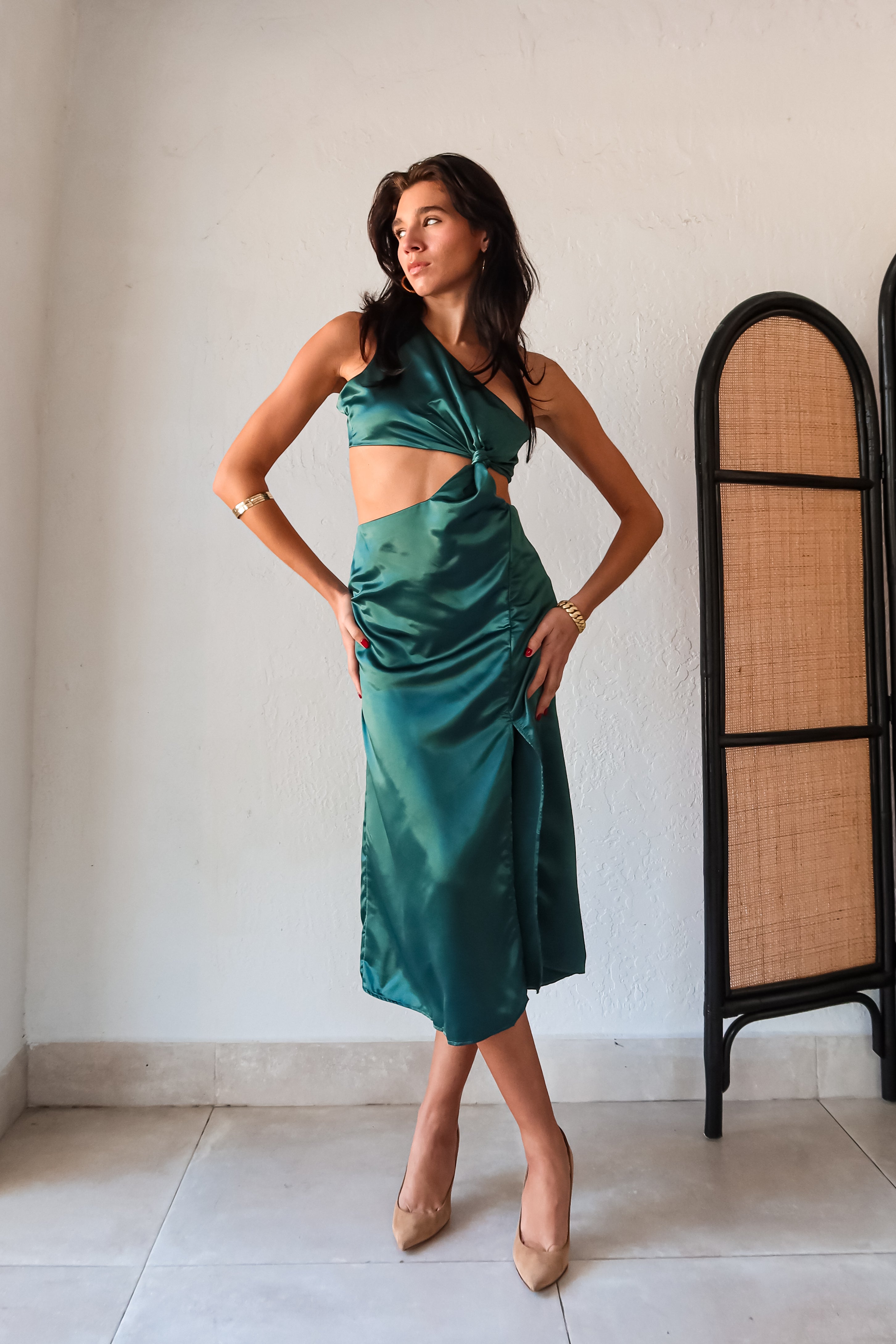 Get ready to slay at cocktail hour with this jewel green satin maxi dress! The one shoulder top with a knot detail adds a touch of glamour, while the left leg slit shows off your killer legs. Ties around back keep the look secure, and a bottom zipper closure makes getting dressed a breeze.