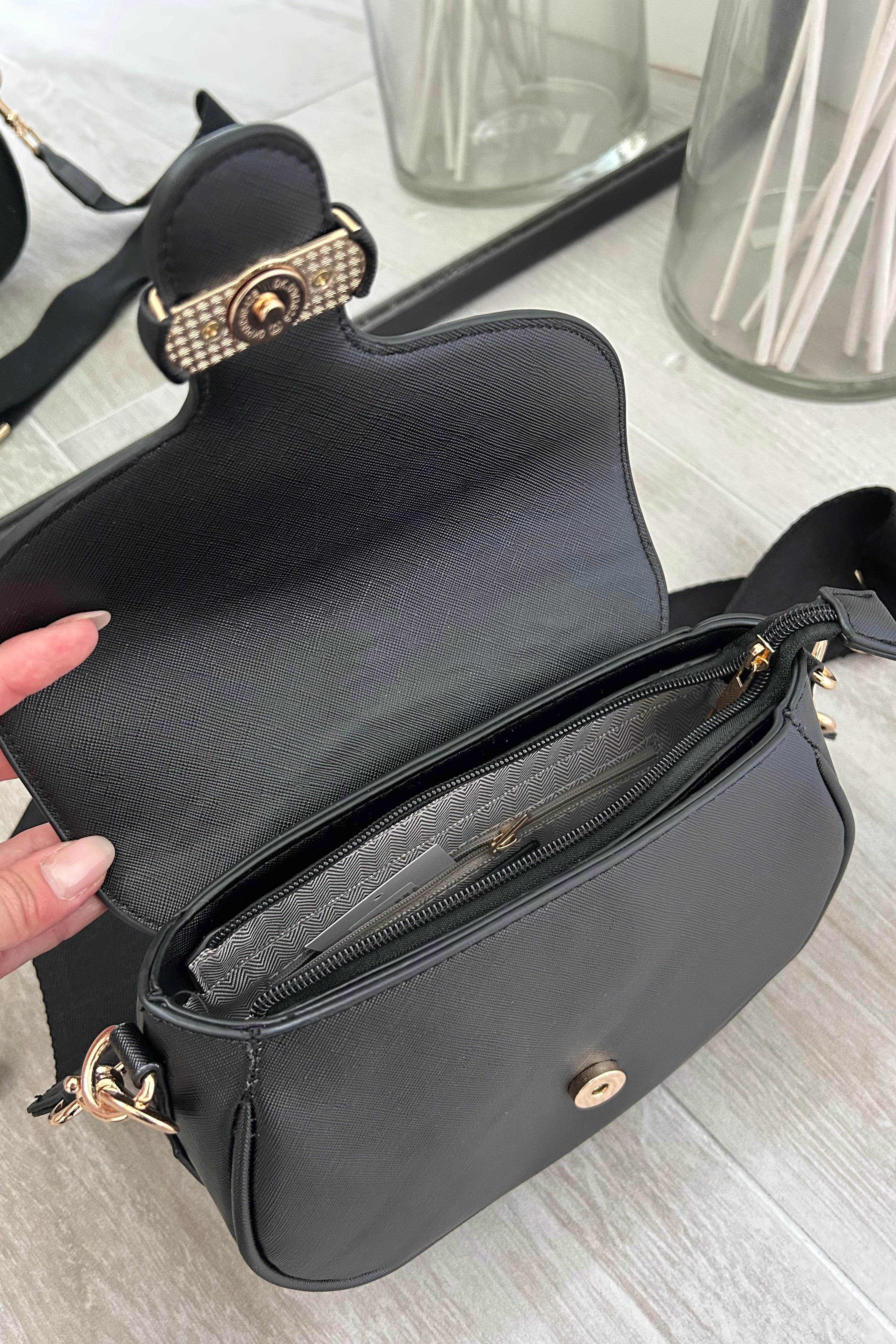 Sling in style with our GRETA TEXTURE CROSSBODY BAG. Made from vegan leather, it features a removable crossbody strap and gold buckle detail. Stay on trend with magnetic and zipper closures. Your perfect carry-all, minus the guilt!