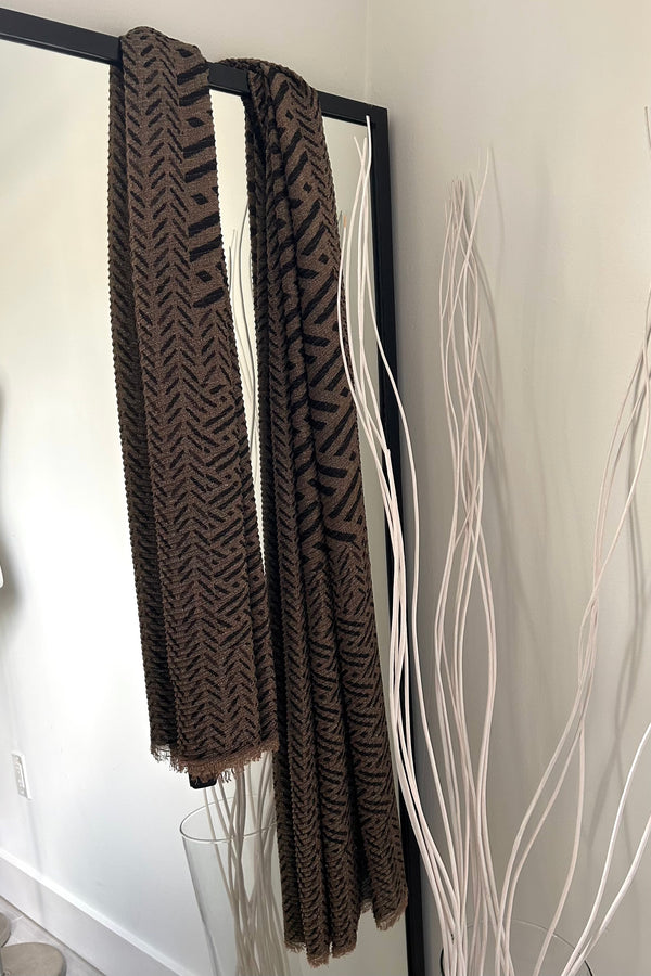 Add some shimmer to your outfit with our IKAT LUREX SHAWL! The metallic lurex thread adds a touch of glamour to the traditional ikat print. Available in black and brown, this shawl is the perfect accessory for a fun and quirky touch to any outfit.