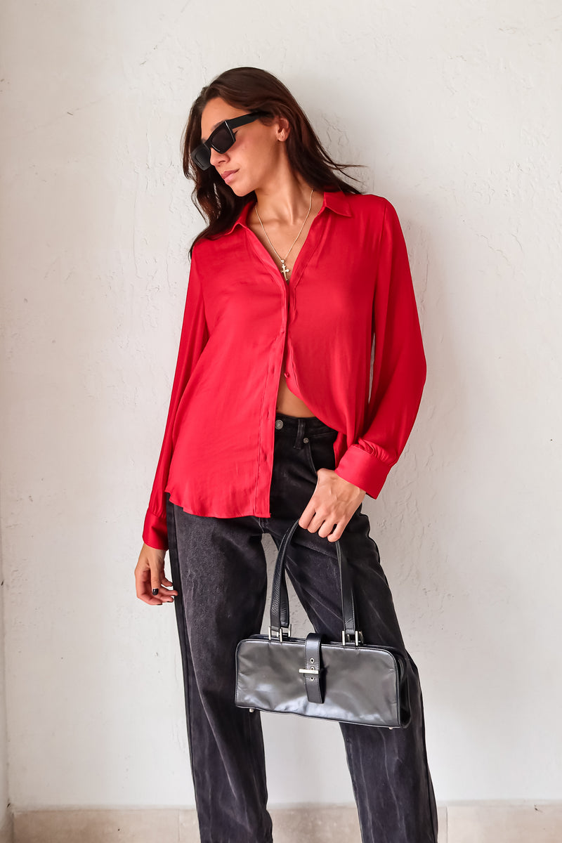 Put a playful twist on your classic work attire with our GABLES LONG SLEEVE BLOUSE. This red, non-lined button down blouse is both lightweight and comfortable for all-day wear. With long sleeves and button wrists, this blouse is perfect for any season. Don't settle for boring office wear, stand out in style!