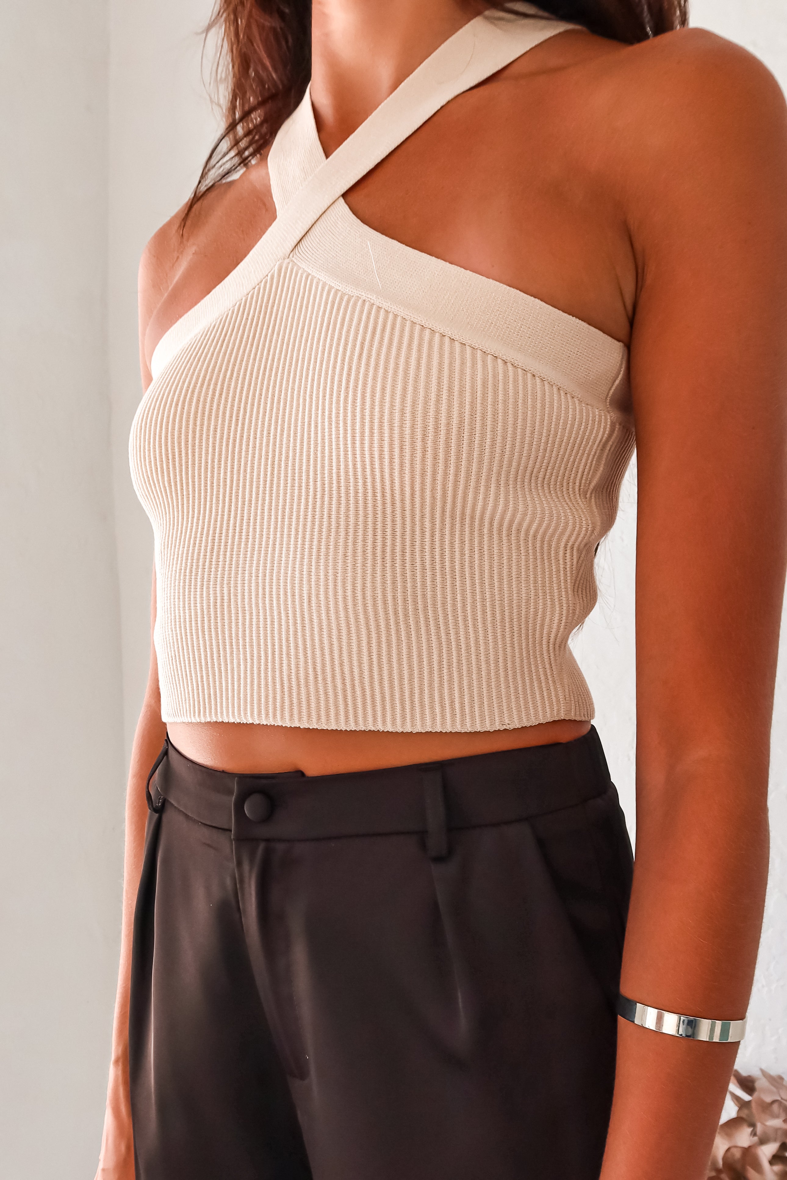 Add a touch of fun to your wardrobe with our Crossroads Knit Top in Cream! This ribbed crop top features a unique X cross design in both the front and back, made with a thick and stretchy luxe ribbed fabric for a comfortable fit. Dress it up or down, day or night, and feel effortlessly stylish!