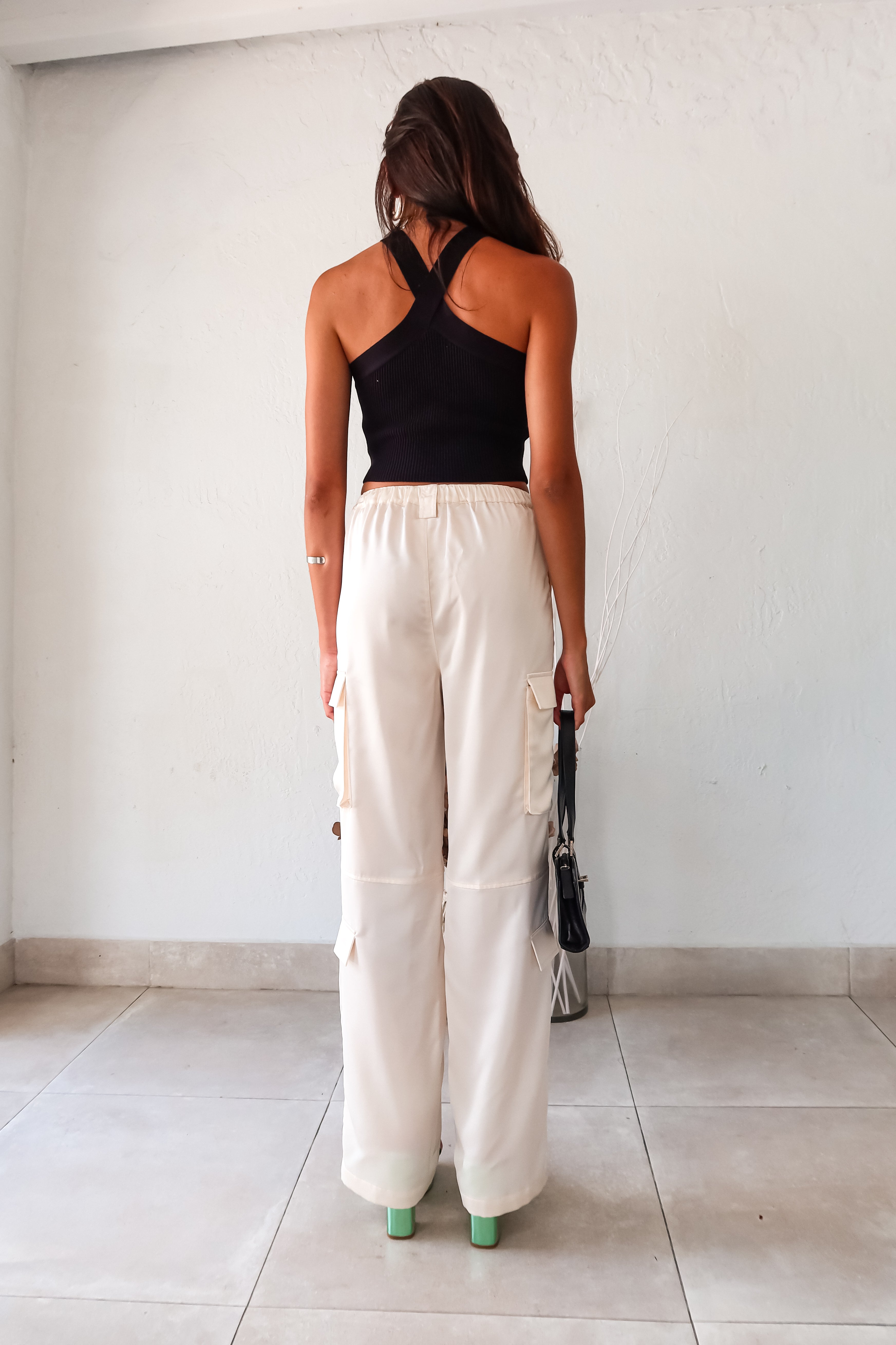 Make a statement on your first date in our FIRST DATE SATIN PANT. The cream color and wide leg style exude elegance, while the side cargo pockets add functionality. With a zipper clip closure and elastic stretch waistband, you'll be comfortable all night long.