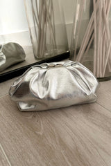 Carry all your essentials with ease in our Silver Pouch Bag. This quirky handbag features a removable shoulder strap and snap buckle closure for added convenience. Perfect for any occasion, be ready to make a statement with this unique and stylish accessory!