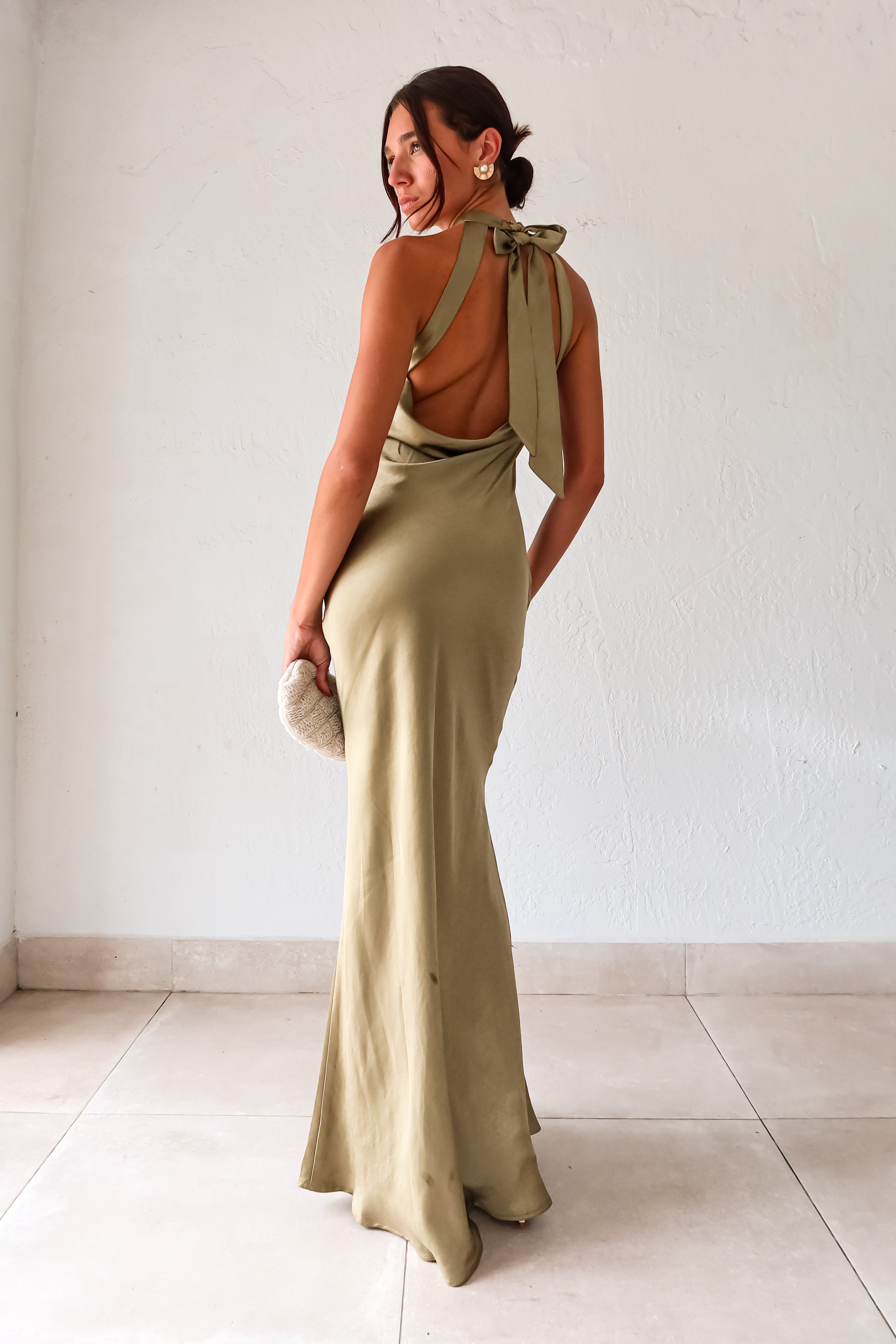 Take your style to the next level with the MAIN EVENT SATIN MAXI DRESS! This luxurious dress features a high neckline and adjustable tie in the back, perfect for creating a flattering silhouette. The draped back adds a touch of elegance to complete your look. Dress to impress with this stunning piece.