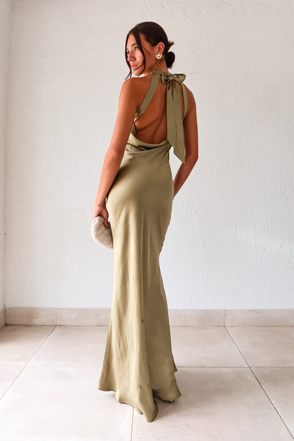 Take your style to the next level with the MAIN EVENT SATIN MAXI DRESS! This luxurious dress features a high neckline and adjustable tie in the back, perfect for creating a flattering silhouette. The draped back adds a touch of elegance to complete your look. Dress to impress with this stunning piece.