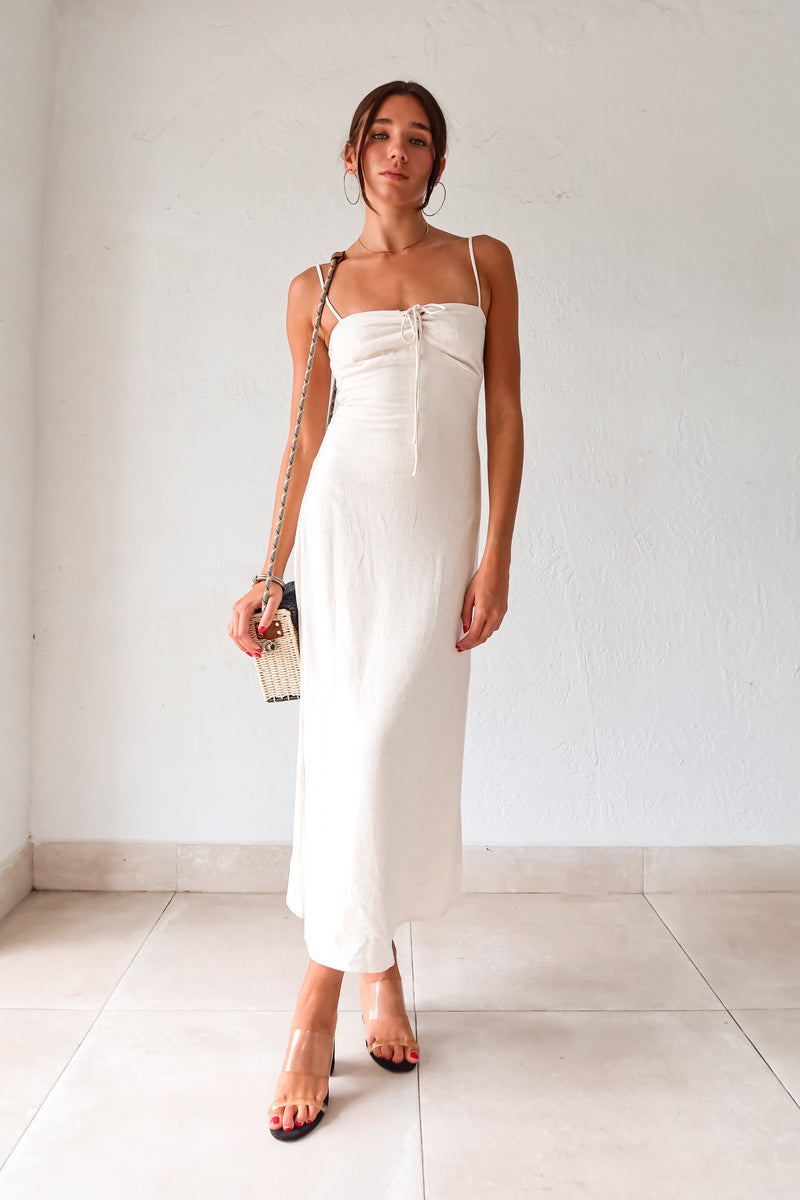 Introducing our MELROSE LINEN MAXI DRESS! This beautiful oatmeal colored dress features adjustable shoulder straps for a perfect fit and a front tie detail for added style. The elastic back straps ensure comfortable wear while the back zipper closure provides easy on and off. Perfect for any occasion!