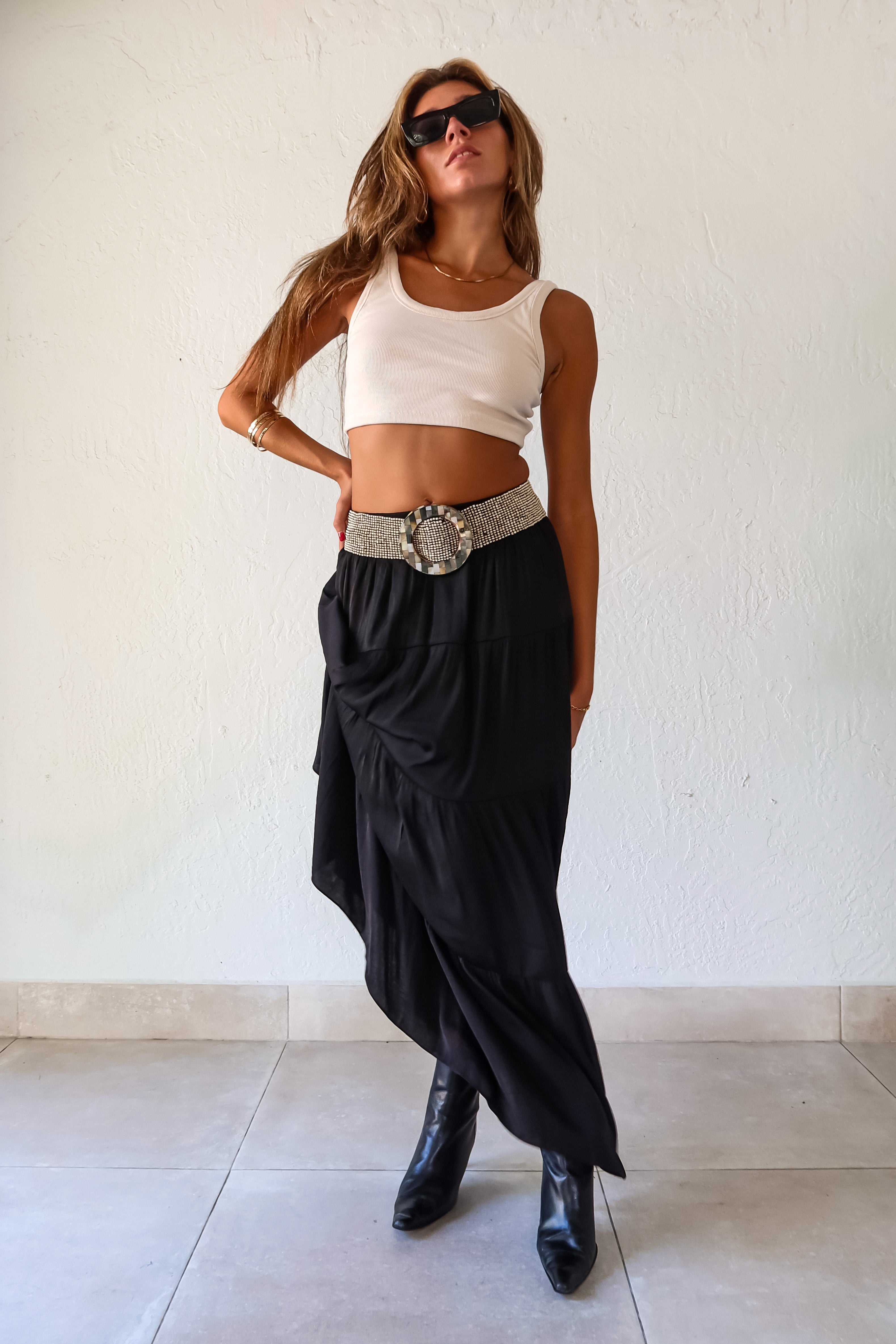  elegance and edge to your wardrobe with the Venus Satin Maxi Skirt in black! The non-stretch satin fabric flows beautifully while the elastic waistband provides a comfortable and flattering fit. Fully lined for a luxe feel 