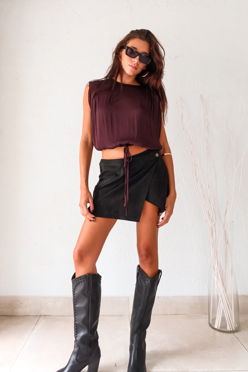 Unleash your inner rebel in the GAL SUEDE MINI SKIRT! Made with black suede, this mini skirt exudes edgy style. The overlap front button closure and back zipper closure add a touch of functionality to this statement piece. Rev up your wardrobe and rock the GAL SUEDE MINI SKIRT!