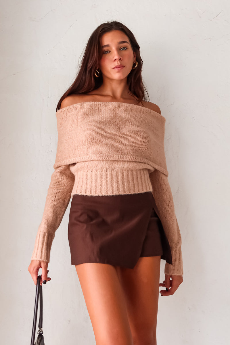 Stay cozy and stylish all season long with our Aspen Sweater! This tan long sleeve sweater features a unique foldover design, ribbed wrist and torso for a snug fit, and stretchy fabric for ultimate comfort. Perfect for any occasion, whether you're out and about or lounging at home.