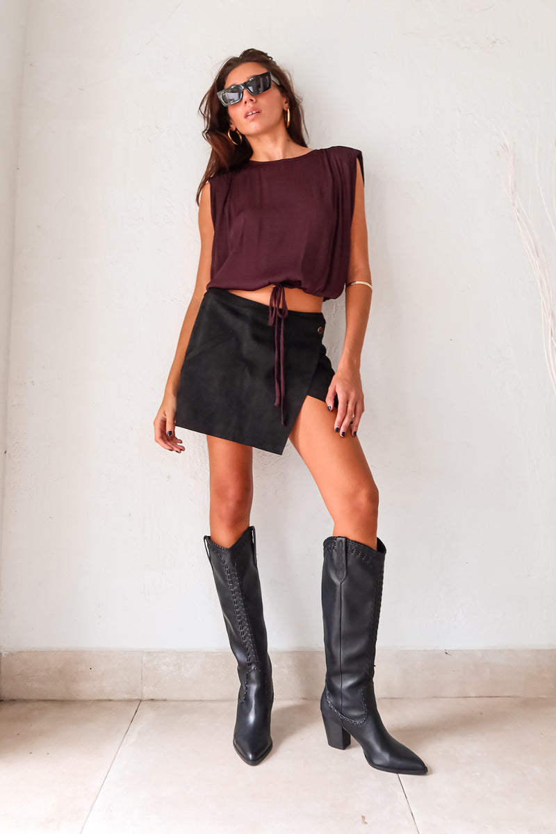 Unleash your inner rebel in the GAL SUEDE MINI SKIRT! Made with black suede, this mini skirt exudes edgy style. The overlap front button closure and back zipper closure add a touch of functionality to this statement piece. Rev up your wardrobe and rock the GAL SUEDE MINI SKIRT!