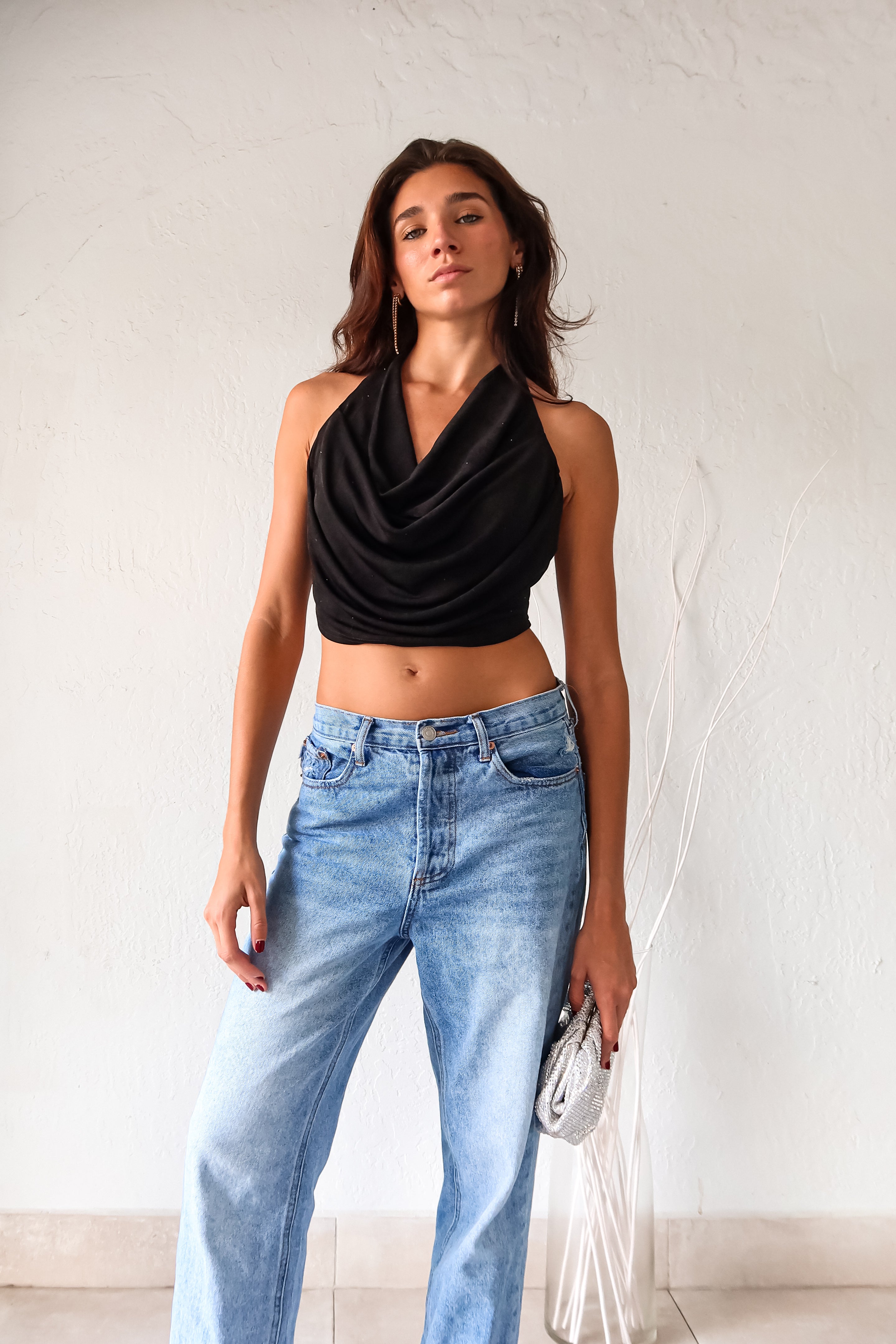 Get ready to dazzle in our Black COCOWALK SLINK HALTER TOP! The cowl bust and rhinestone accents add a touch of glamour to this playful halter. Made with stretchy fabric for all-day comfort. Tie it around your neck for a perfect fit.&nbsp;