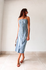 Get ready to rock a laid-back look with our Cypress Denim Midi Dress. This versatile piece features a front button down closure and adjustable shoulder straps for a customizable fit. The stretchy fabric and smocked backing provide ultimate comfort, while the chest stitch detail adds a touch of unique style. Non lined for a lightweight feel.