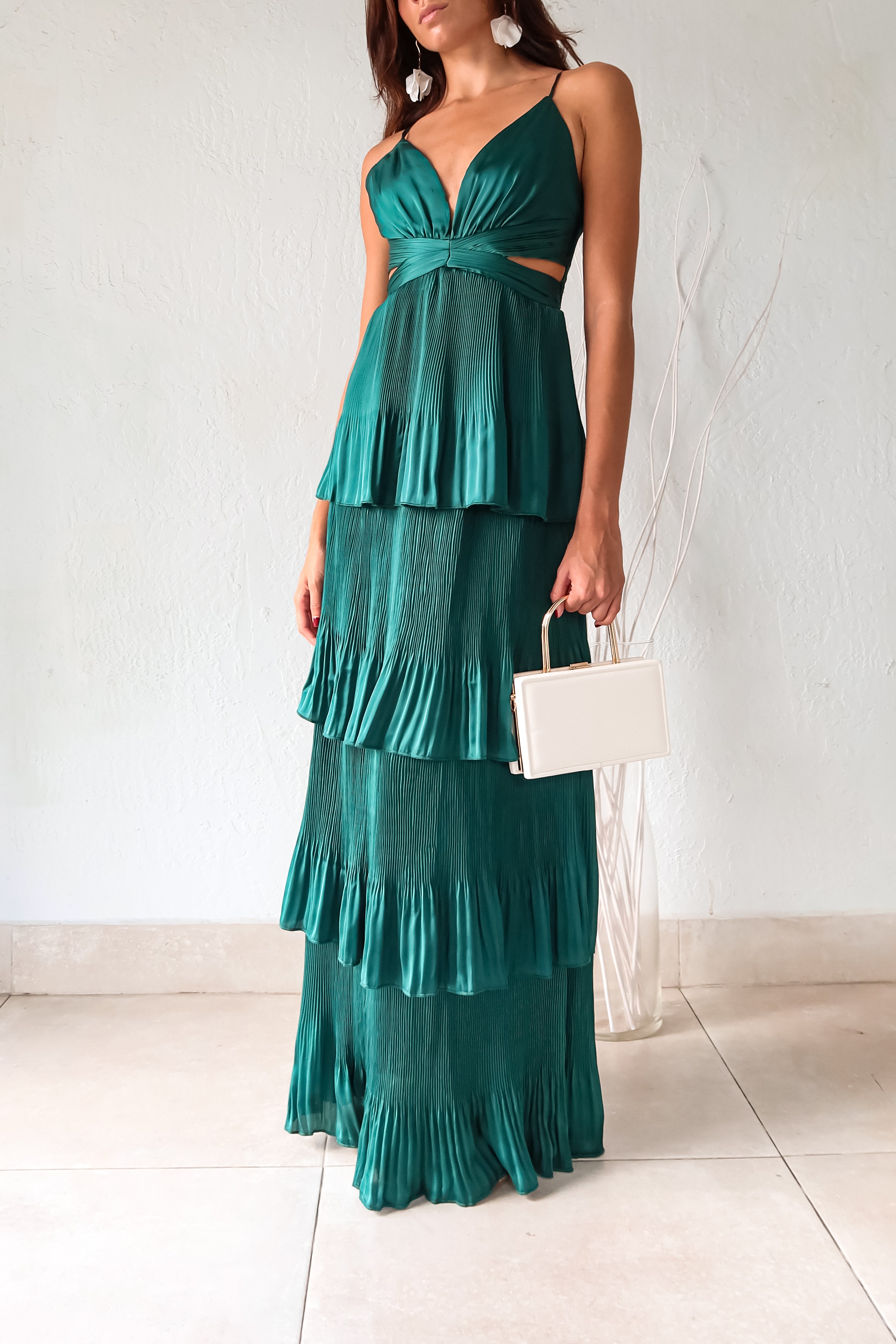 Turn heads in the PARISIAN GARDEN SATIN MAXI DRESS. With an emerald green satin fabric, adjustable shoulder straps, and a back zipper closure, this dress is both comfortable and stunning. The chiffon overlap detail adds a touch of elegance to this playful and chic piece.