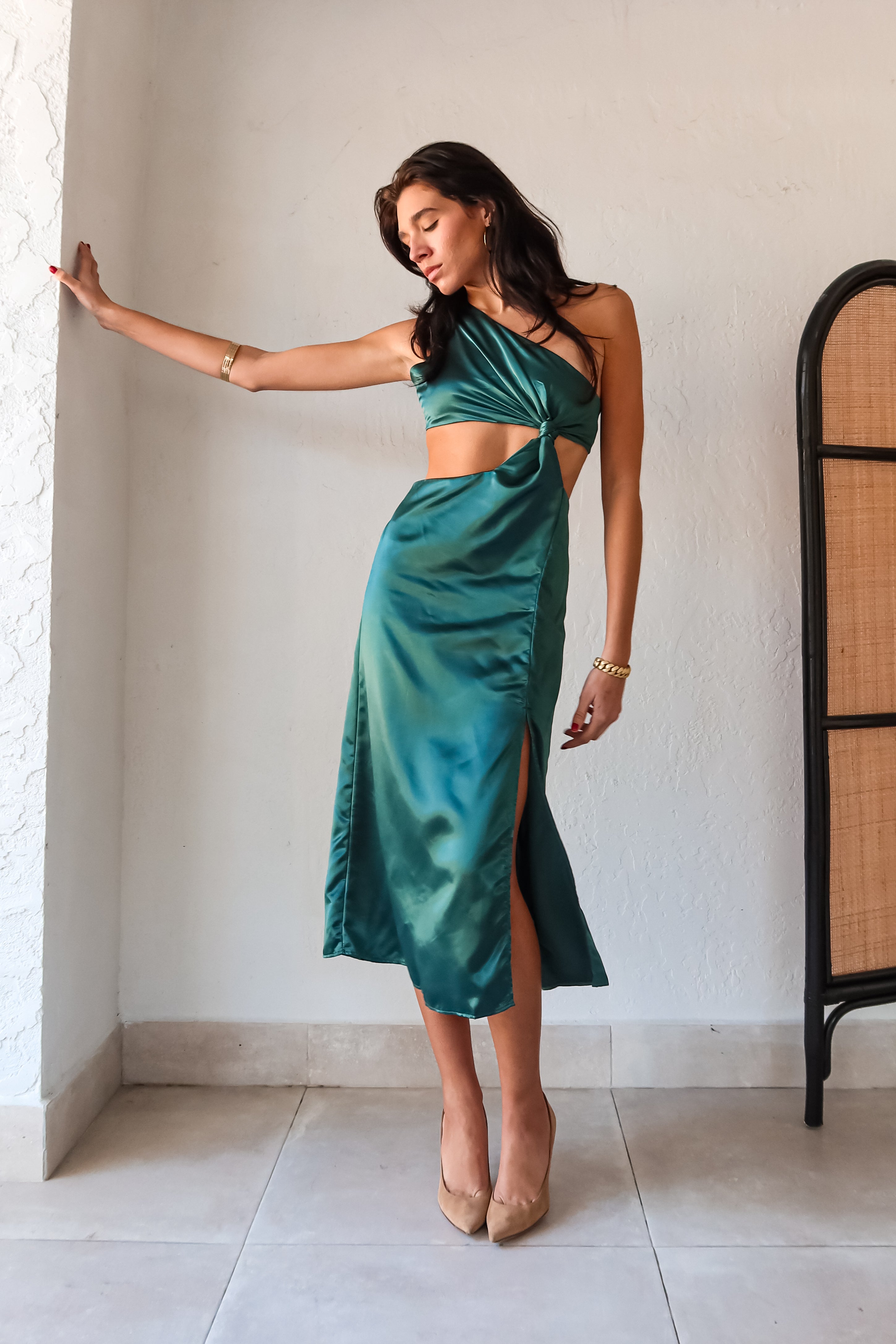 Get ready to slay at cocktail hour with this jewel green satin maxi dress! The one shoulder top with a knot detail adds a touch of glamour, while the left leg slit shows off your killer legs. Ties around back keep the look secure, and a bottom zipper closure makes getting dressed a breeze.