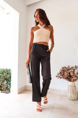 Get ready to make some bold moves with these black satin pants. The button and zipper closure, along with the elastic waist band, ensure a comfortable fit while the front pockets add functionality. Perfect for a night out on the town, these pants will have you looking stylish and feeling confident.