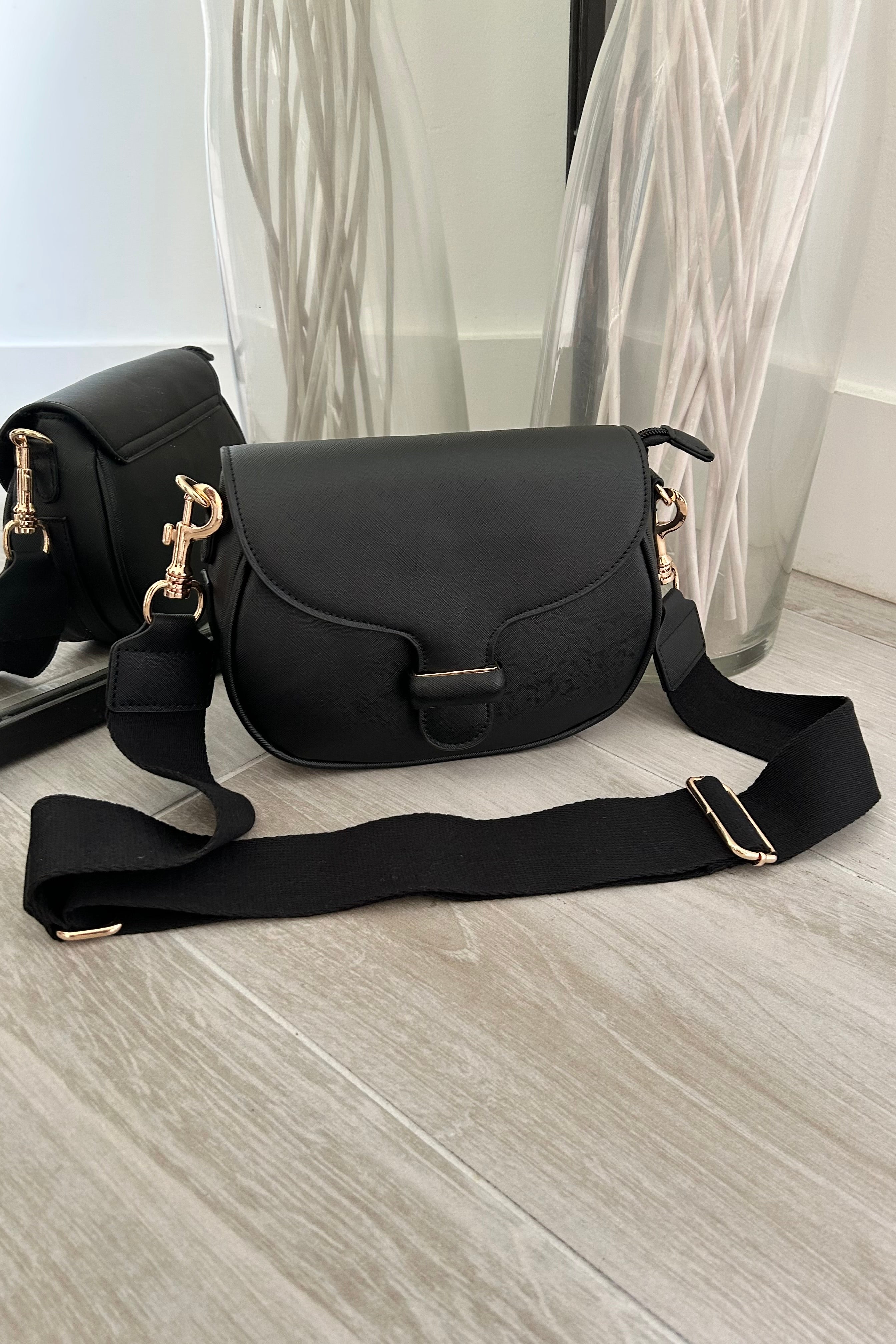 Sling in style with our GRETA TEXTURE CROSSBODY BAG. Made from vegan leather, it features a removable crossbody strap and gold buckle detail. Stay on trend with magnetic and zipper closures. Your perfect carry-all, minus the guilt!