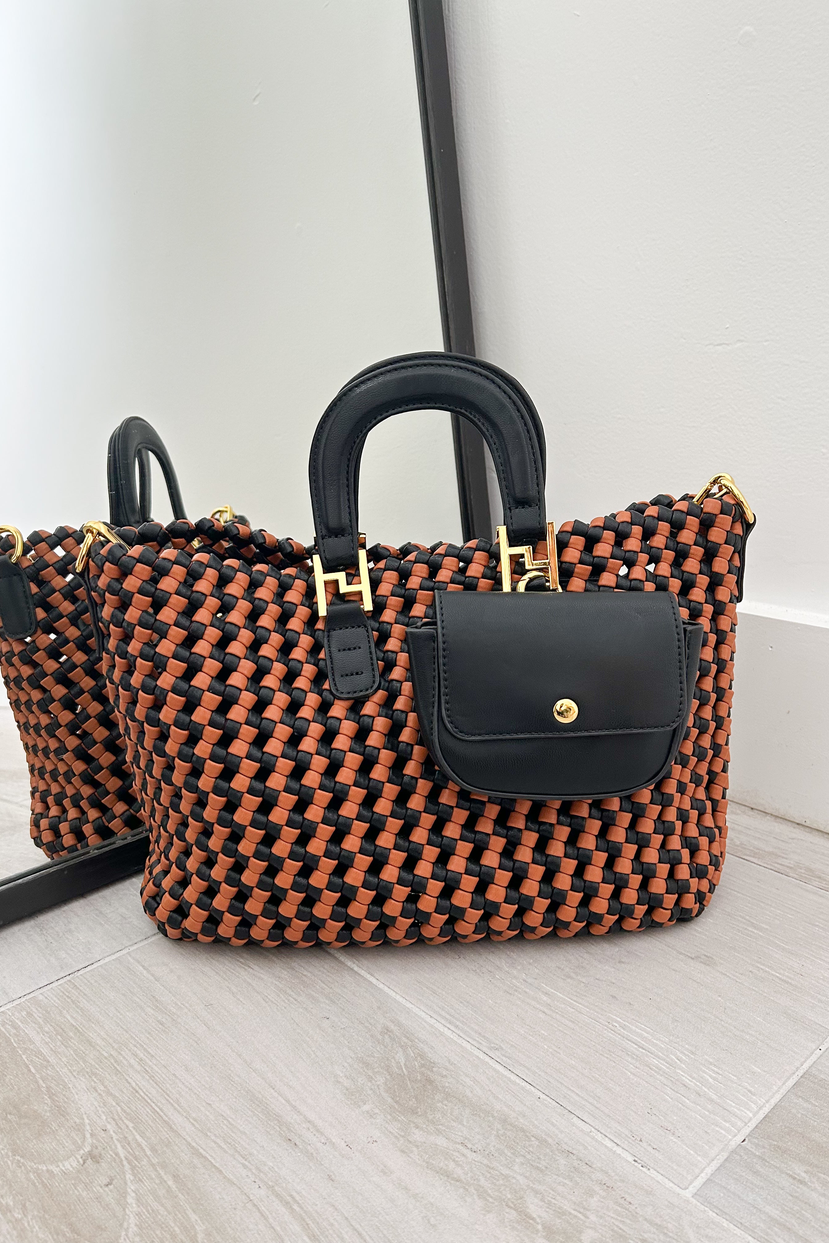 Introducing our MIRANDA WOVEN TOTE - the perfect blend of style and functionality. Featuring a brown and black woven design, this tote exudes effortless elegance. Stay organized with the removable inner and side pouches, while the gold buckle detail adds a touch of sophistication. Upgrade your tote game today!