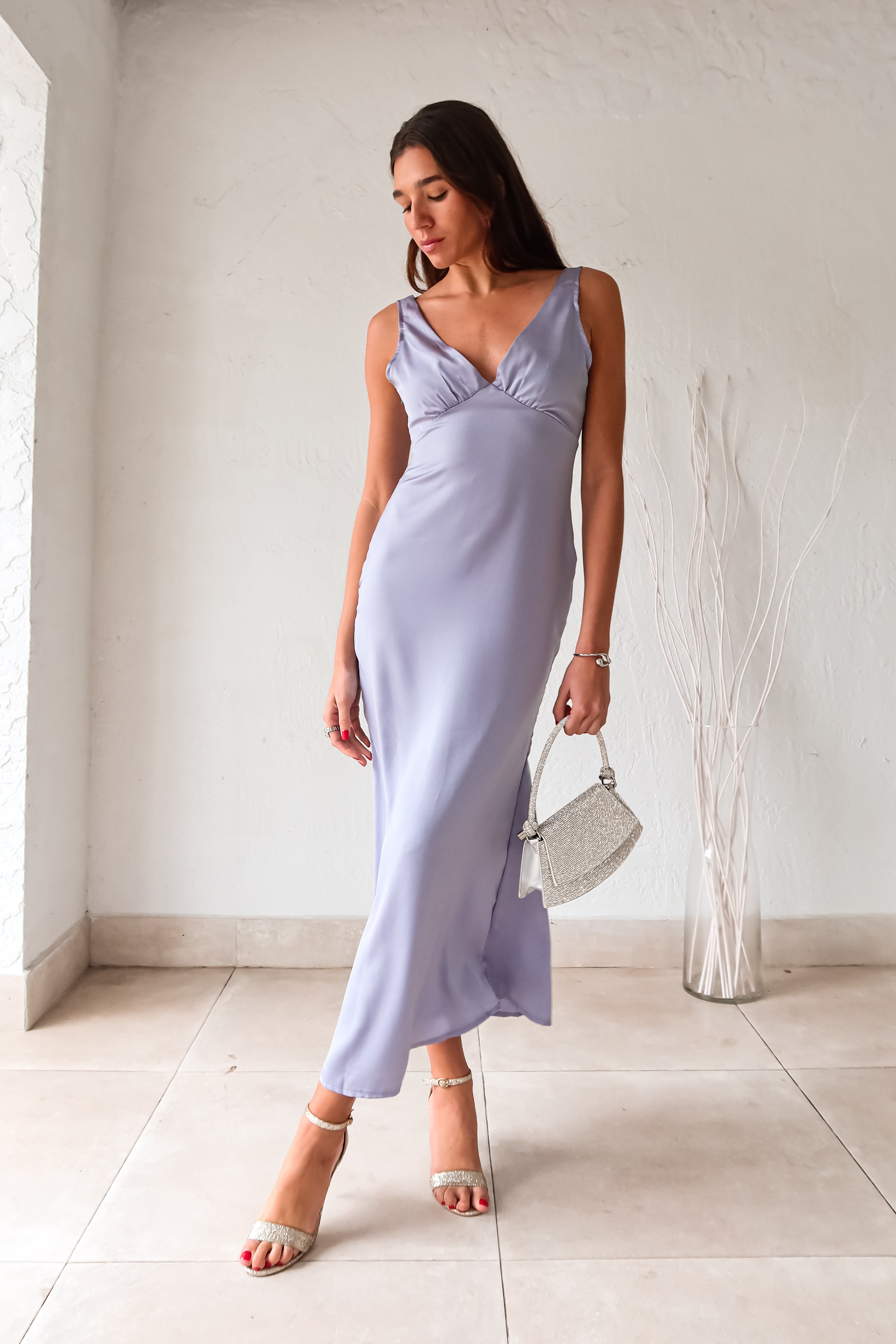 Indulge in luxury with our Sultry Satin Maxi Dress. This lilac stunner features a triangle top design and a side zipper closure for a secure fit. Elevate your style and feel effortlessly chic in this must-have piece.