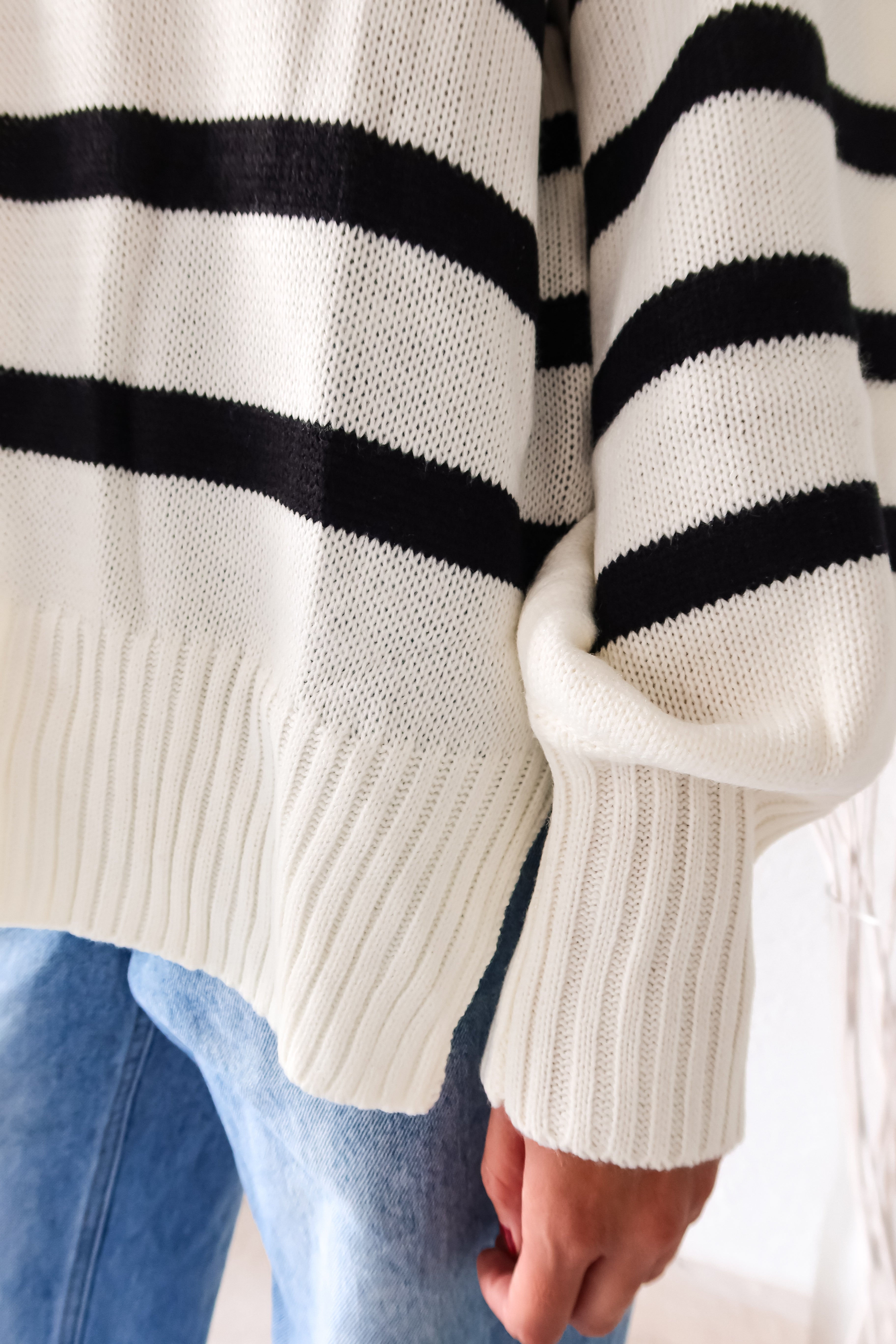 Get ready to groove with our Grove Walk Striped Sweater! This white and black striped sweater features ribbed wrist and waistline for a comfortable and customizable fit. With stretchy fabric and one size fitting XS-L, this sweater is perfect for any occasion.