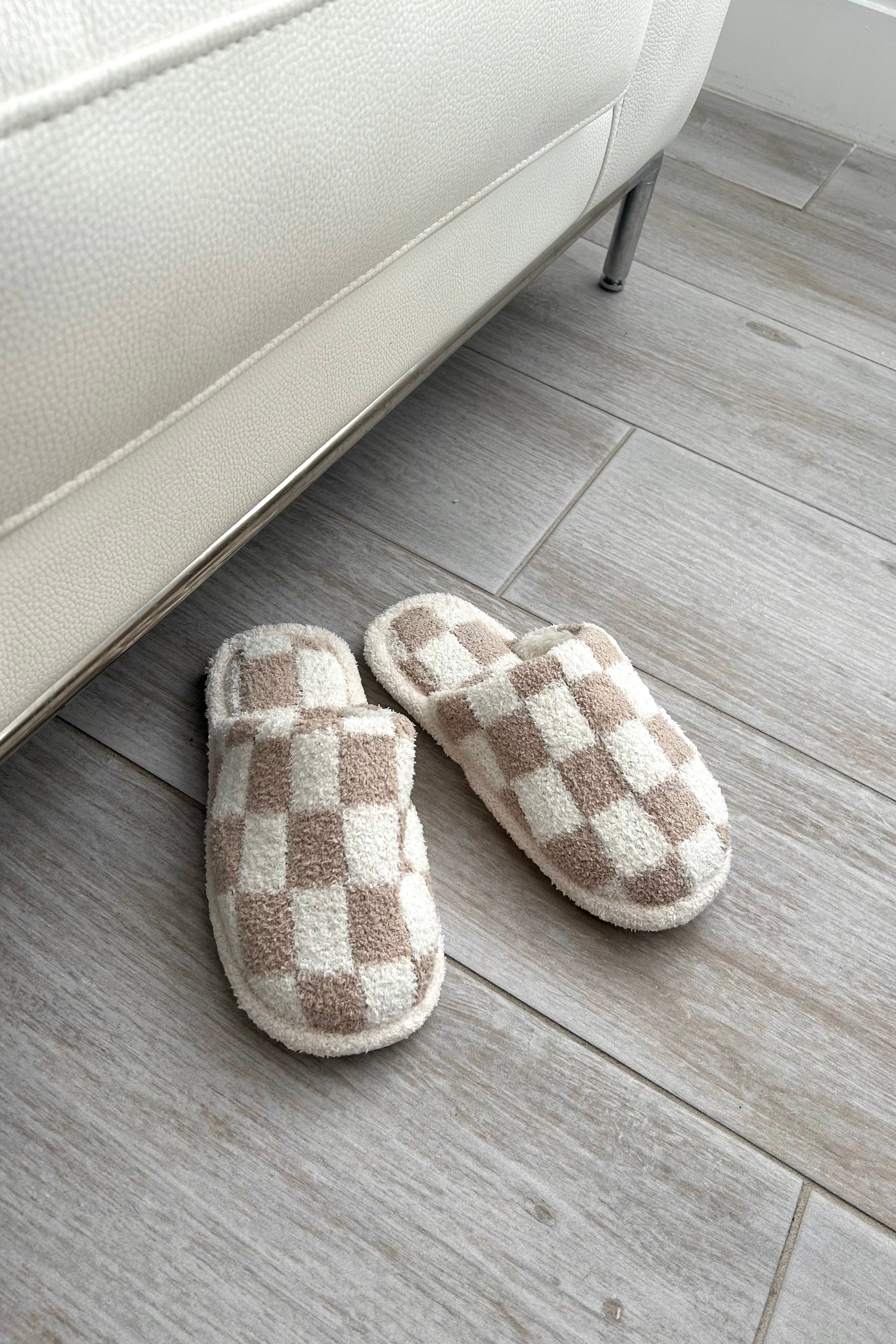 Step up your cozy game with our Checkmate Slippers! These white and khaki checker pattern slippers are not only stylish, but also made with comfy plush fabric for ultimate comfort. The cushioned sole will keep your feet happy all day long. It's game over for uncomfortable slippers!